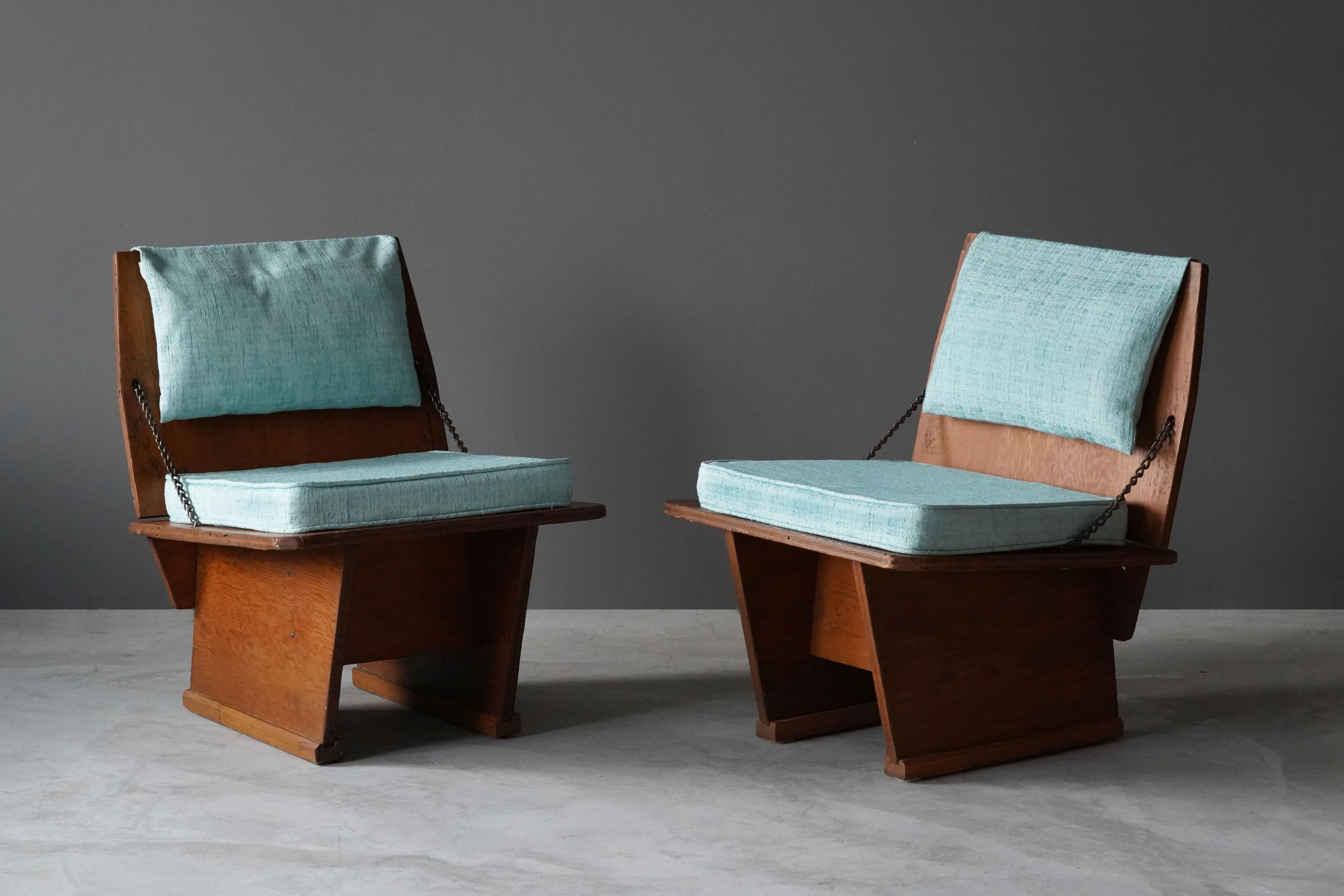 A rare pair of lounge chairs / slipper chairs designed by Frank Lloyd Wright produced by his Taliesin studio. Produced in limited numbers for Lloyd Wright's famous Unitarian Church in 1951. Marked. Purchase includes rare physical documentation.
