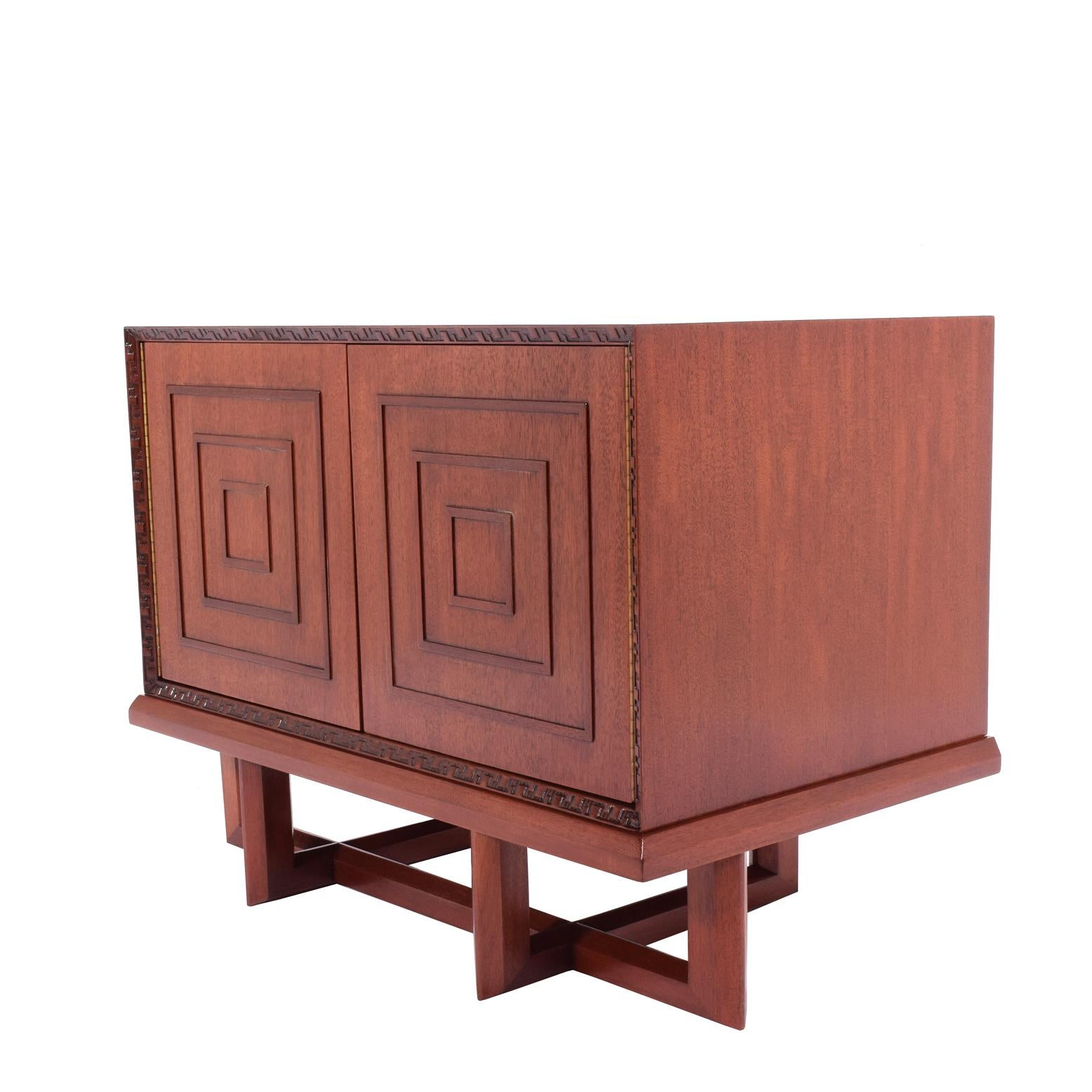 Two-door cabinet with one adjustable shelf design by Frank Lloyd Wright # 2005 in 1955 for Heritage Henredon, stamp in red inc on the back.
