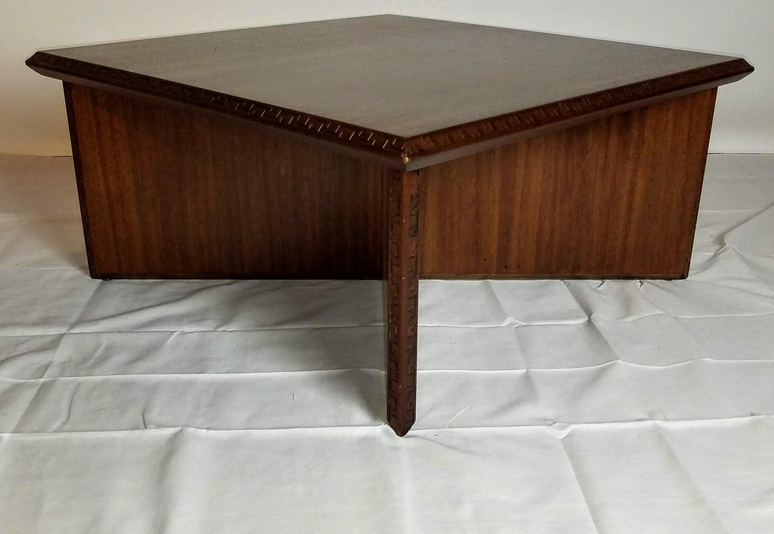 A Frank Lloyd Wright low square mahogany cocktail or center table for Heritage Henredon's Taliesin line of furniture that was briefly in production between 1955 and 1956.
The Greek key motif that borders the top and each of the four vertical