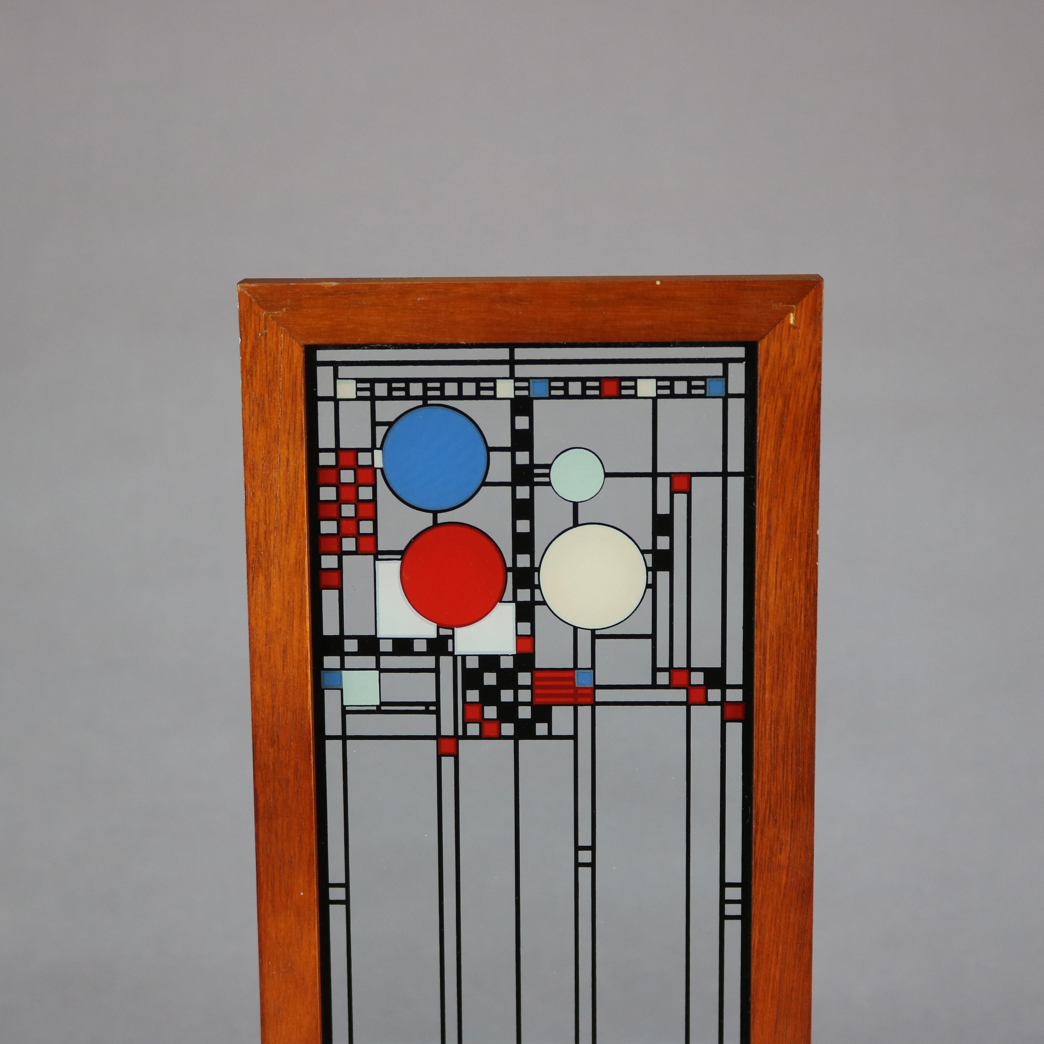 Frank Lloyd Wright Foundation (FLLW Fdn.), Metropolitan Museum of Art (MMA) Prairie School glass panel depicts enameled replica of Avery Coonley Playhouse glass panels, seated in wood stand with identifying brass plate as photographed, 20th