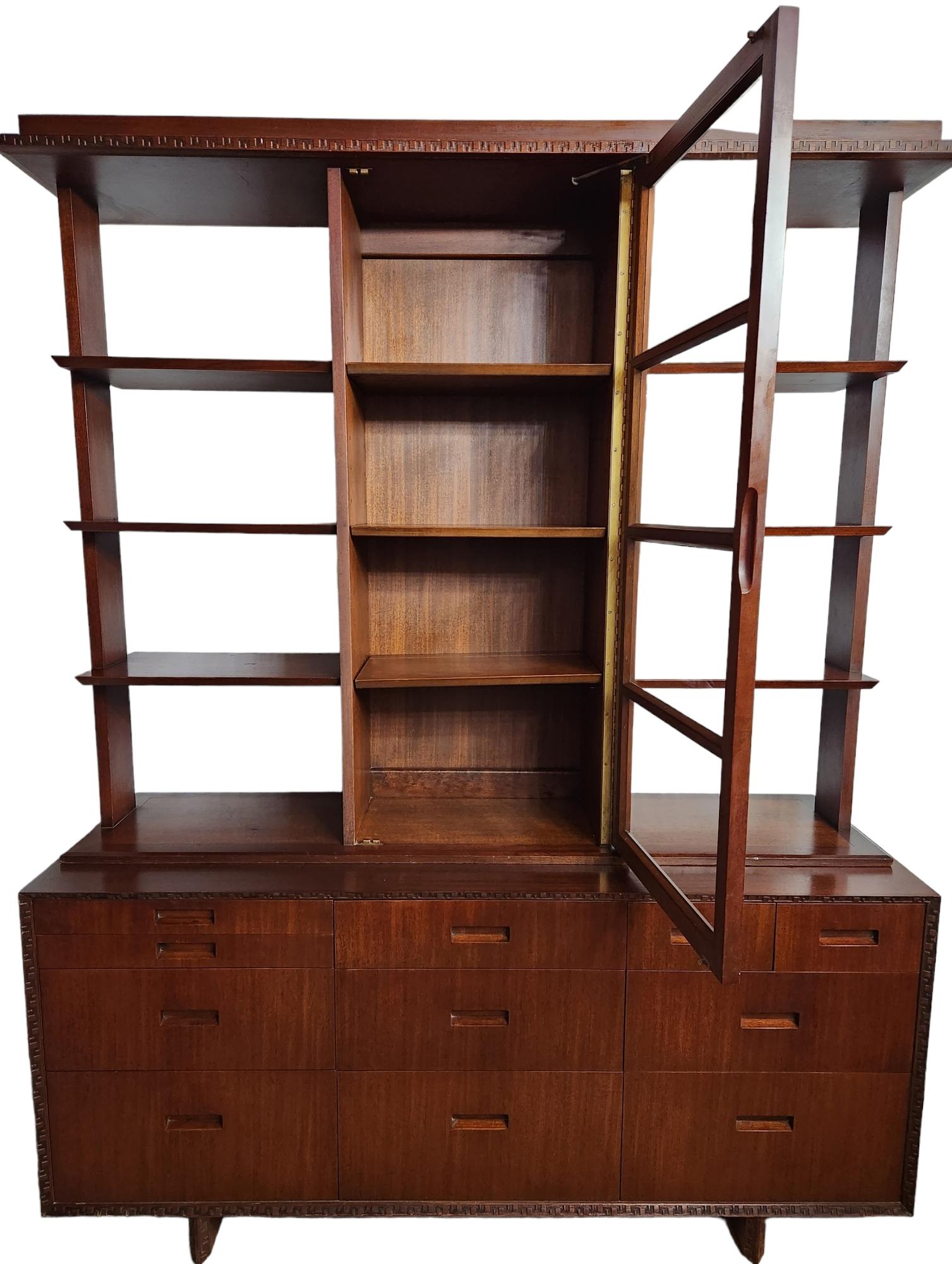 Beautiful mahogany sideboard / china closet designed by Frank Lloyd Wright for Heritage Henredon in 1955 as part of his Taliesin line.
The right upper corner drawer is stamped on the inside with Heritage- Henredon trademark and Frank Lloyd Wright's