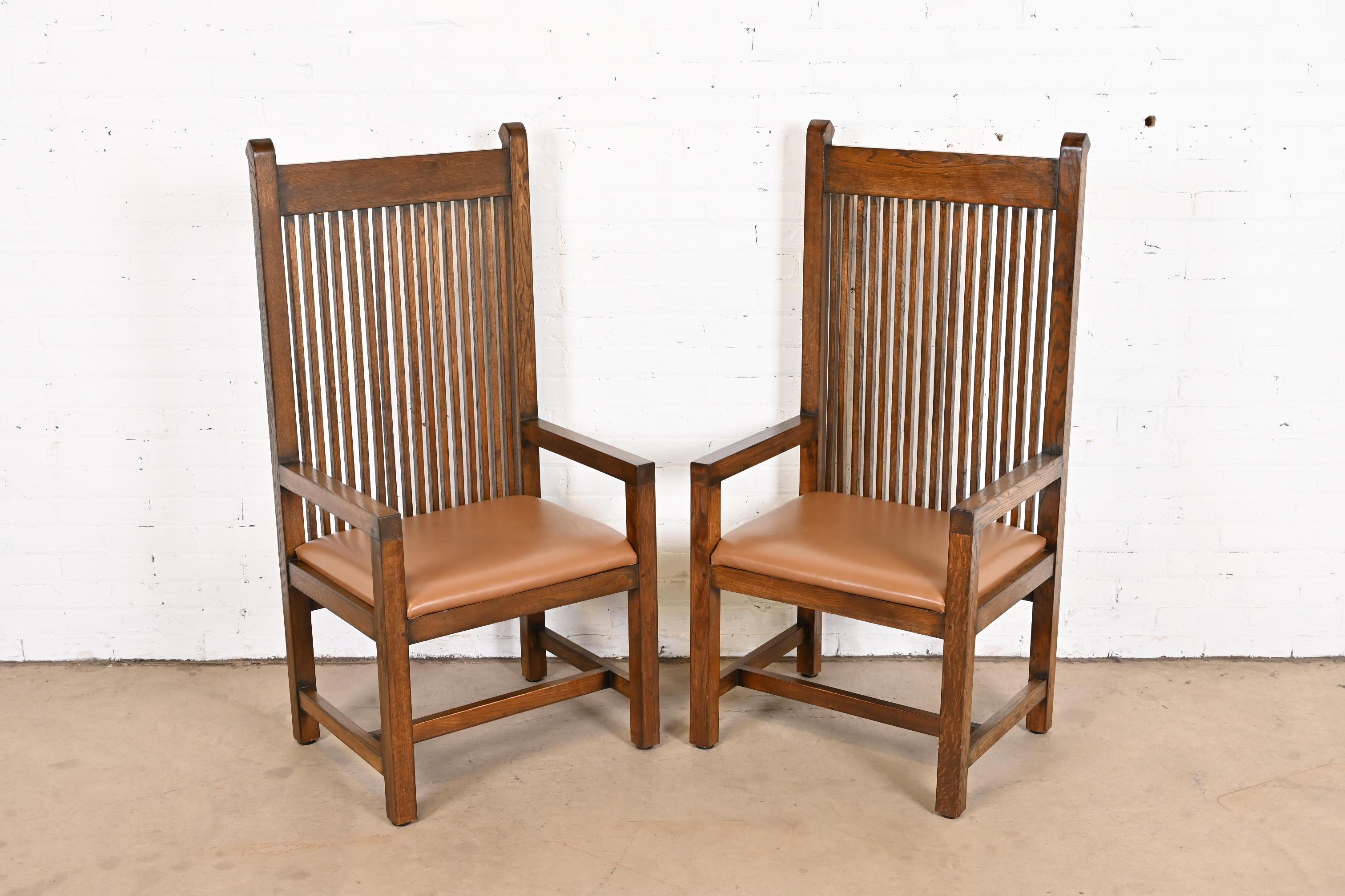 An exceptional pair of Mission or Arts & Crafts style high back club chairs or dining chairs

In the manner of Frank Lloyd Wright

USA, Circa 1980s

Solid quarter sawn oak frames, with leather seats.

Measures: 23.75