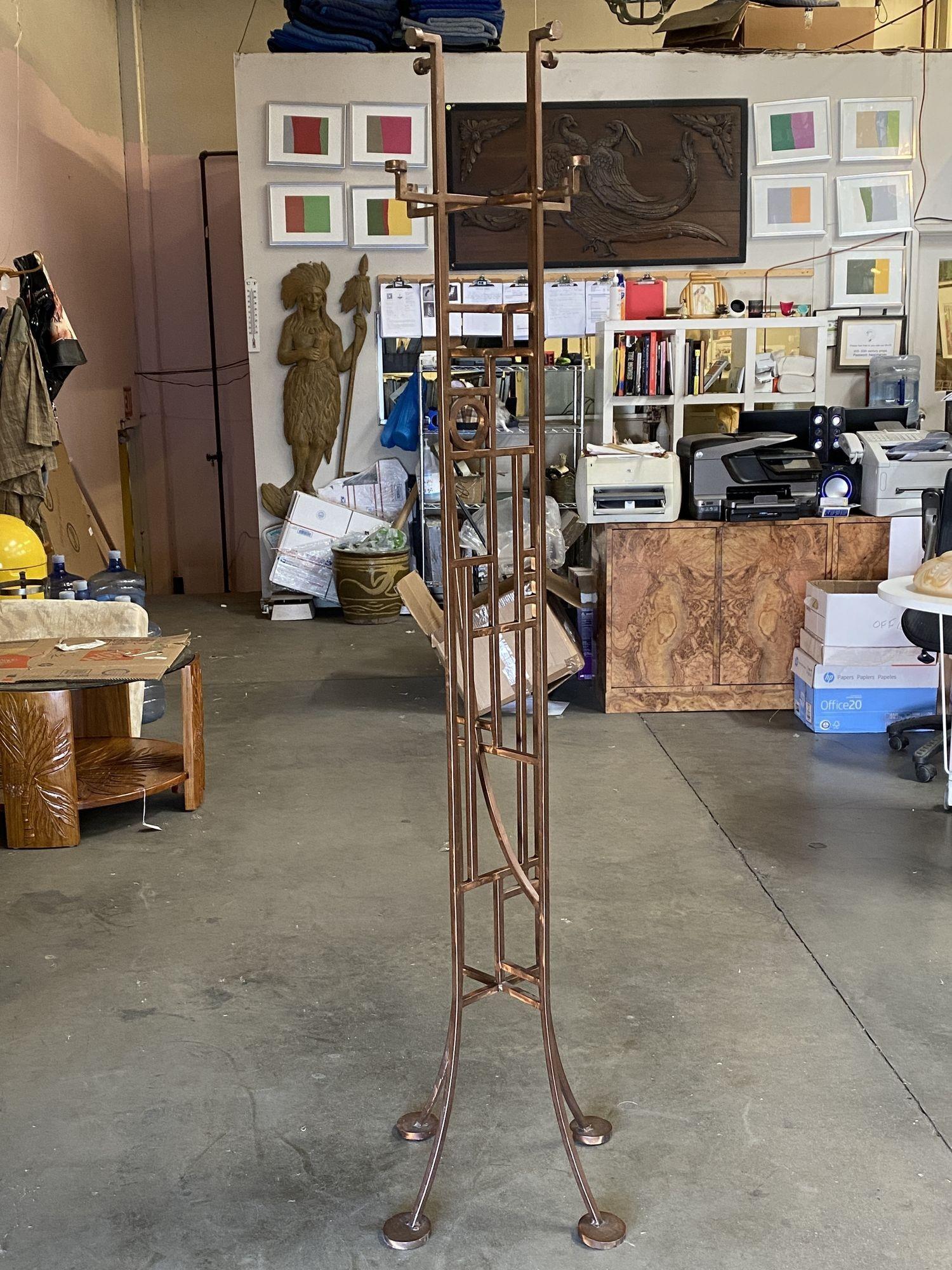 Neo Art Deco hall tree reminiscent of Frank Lloyd Wright, is executed in beautifully hand constructed in tubular steel finished in copper patina throughout. The body is fashioned after early Art Deco with geometric shapes throughout inside a