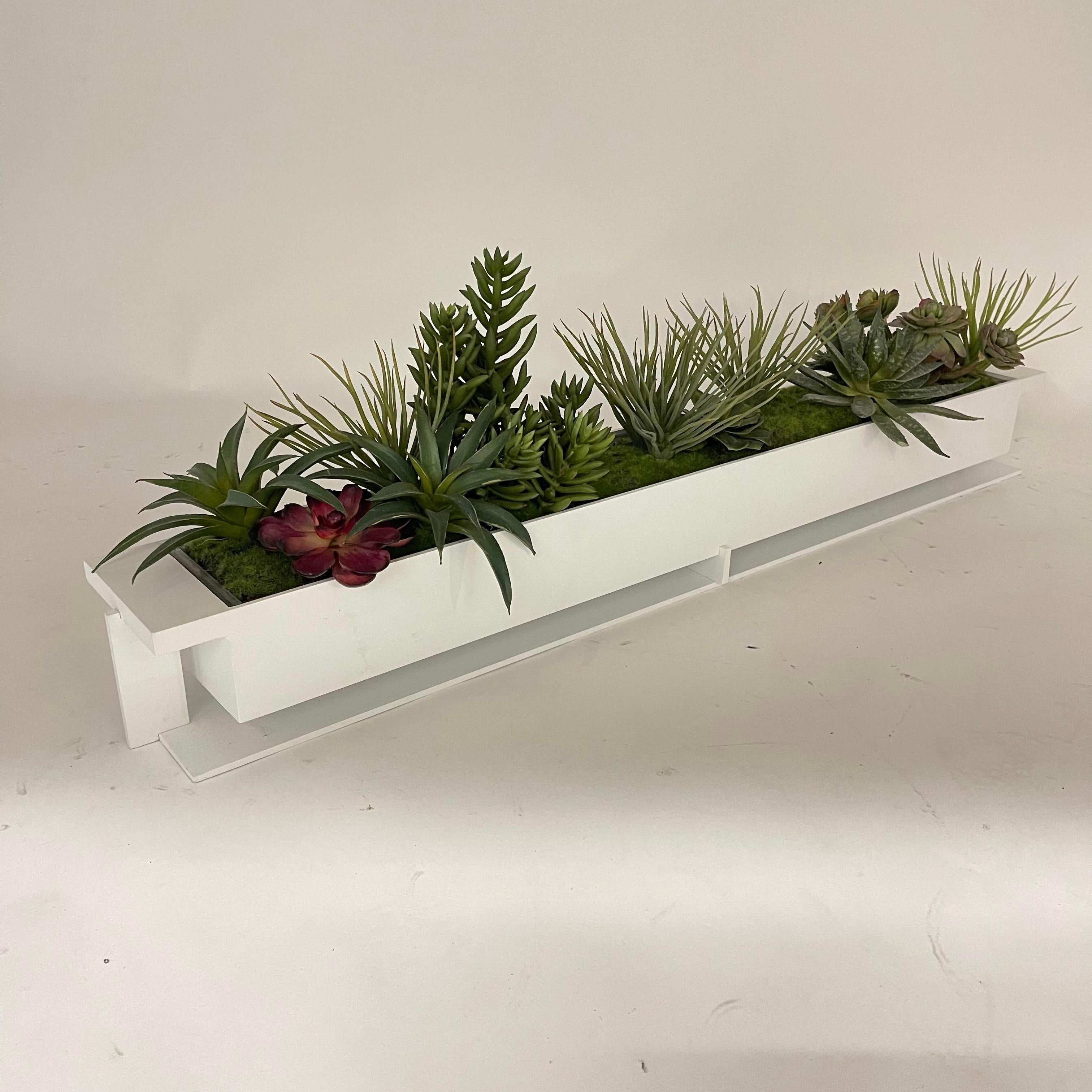 Versatile planter or centerpiece rendered in white powder coated cold steel with a clear translucent lucite acrylic insert and a decorative high end faux succulent arrangement.  USA, 2020.

can be used indoor or outside, can be used with or without