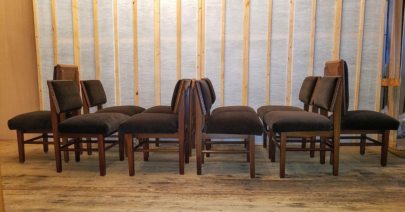 Frank Lloyd Wright suite of ten mahogany Henredon dining chairs dating from the mid-late 1950s.
An assembled group with a pair of high back side chairs surrounded by eight standard side chairs. Four with the Taliesin incised Greek key border on just