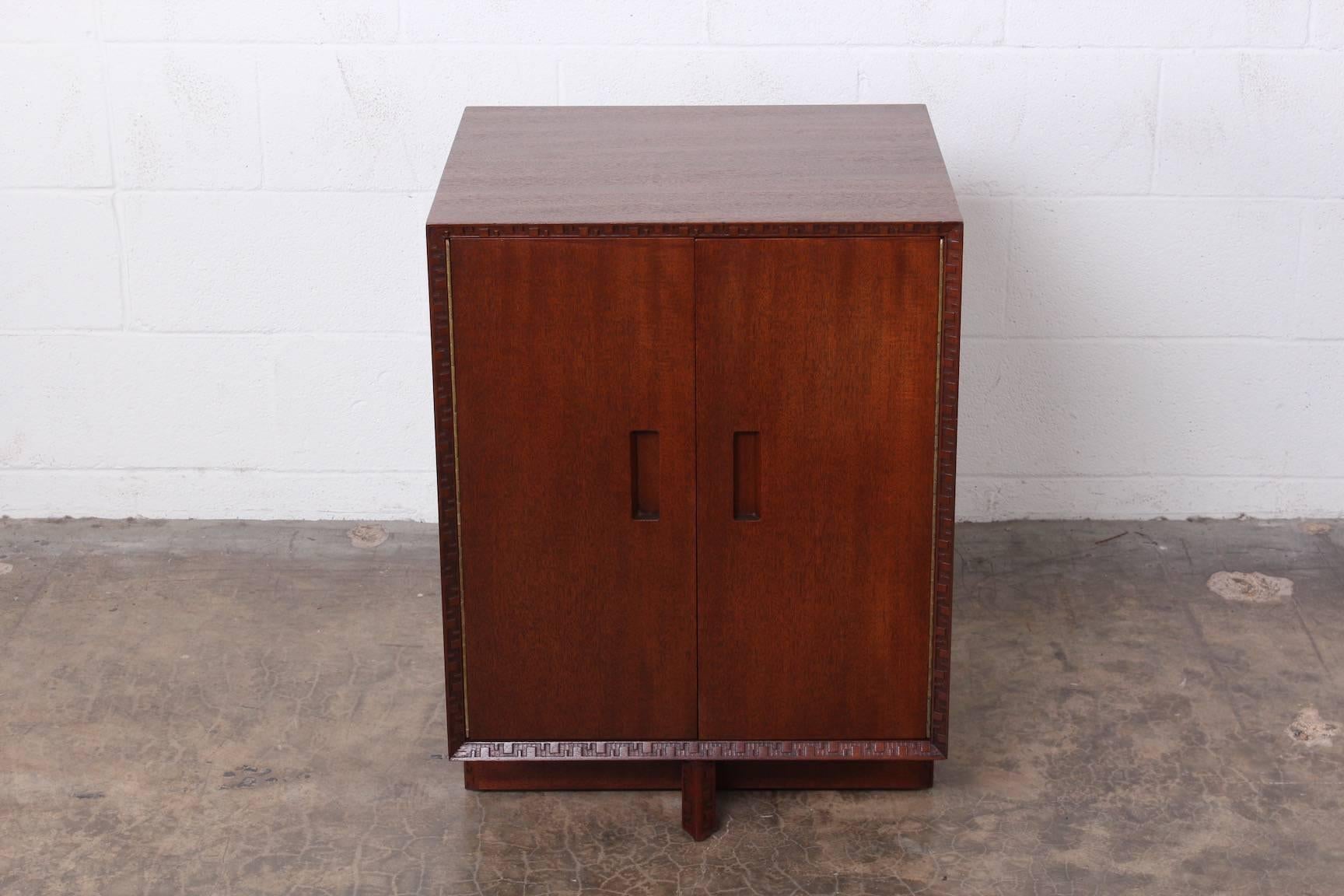 A two-door mahogany cabinet designed by Frank Lloyd Wright for Henredon.