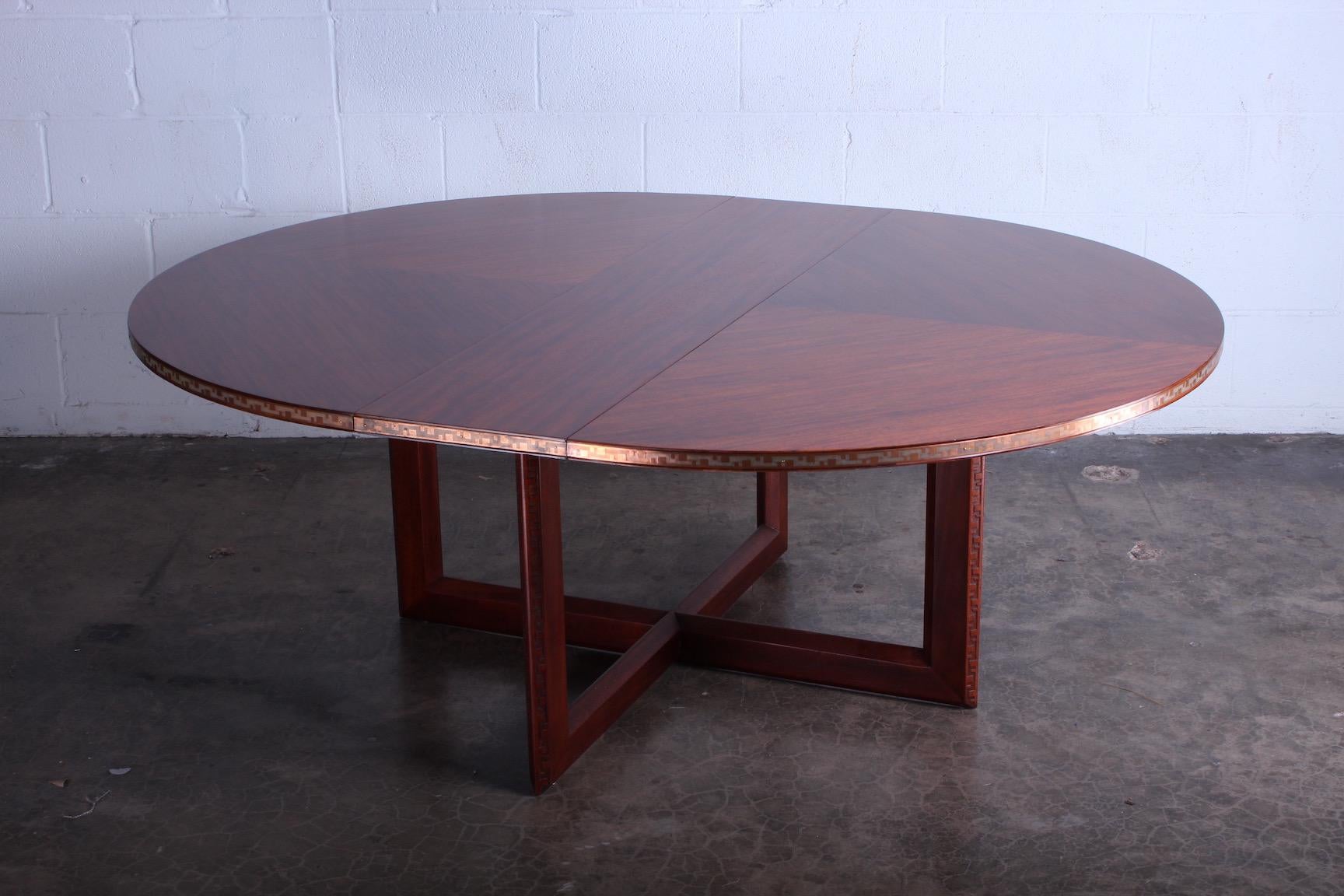Frank Lloyd Wright for Heritage Henredon. Taliesin dining or game table. Mahogany table, concentric square pattern bookmatched with embossed copper 