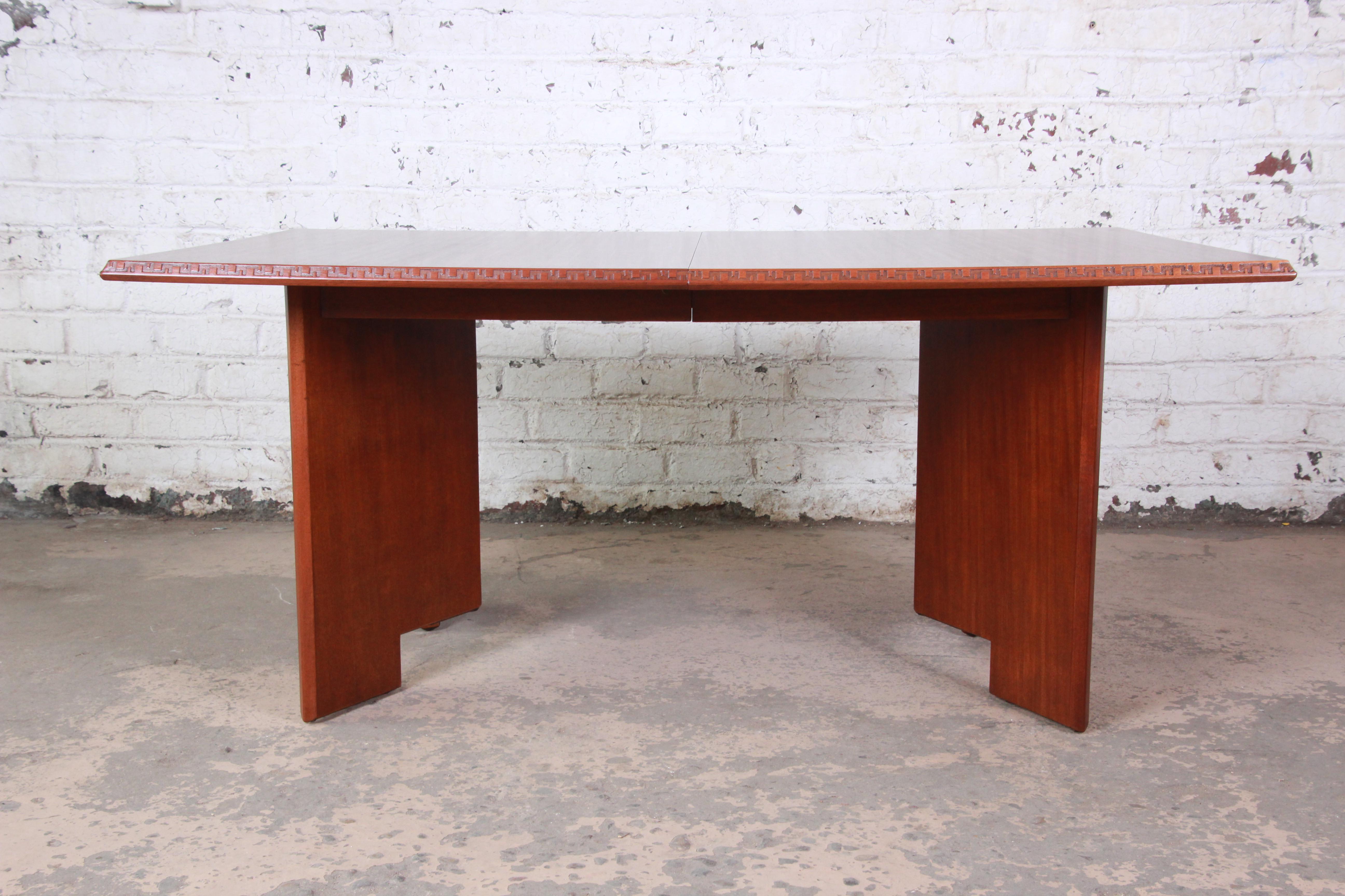 A rare and outstanding mahogany extension dining table designed by Frank Lloyd Wright for his 