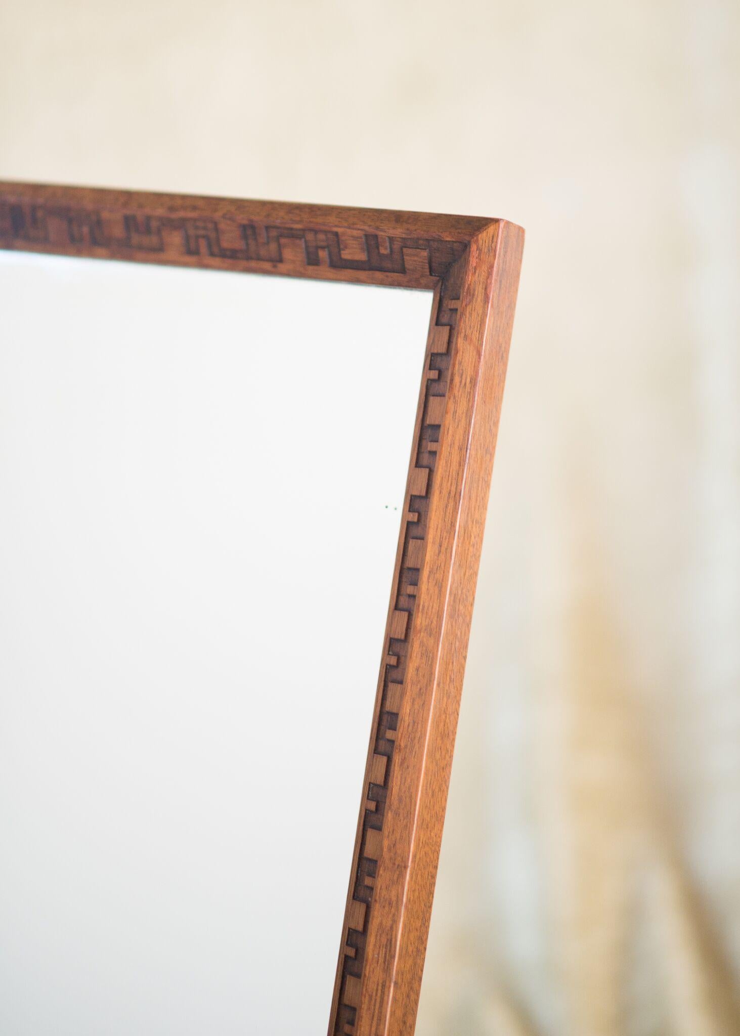 Frank Lloyd Wright for Henredon.

Solid mahogany frame with Wright's signature taliesin carved design with stand.