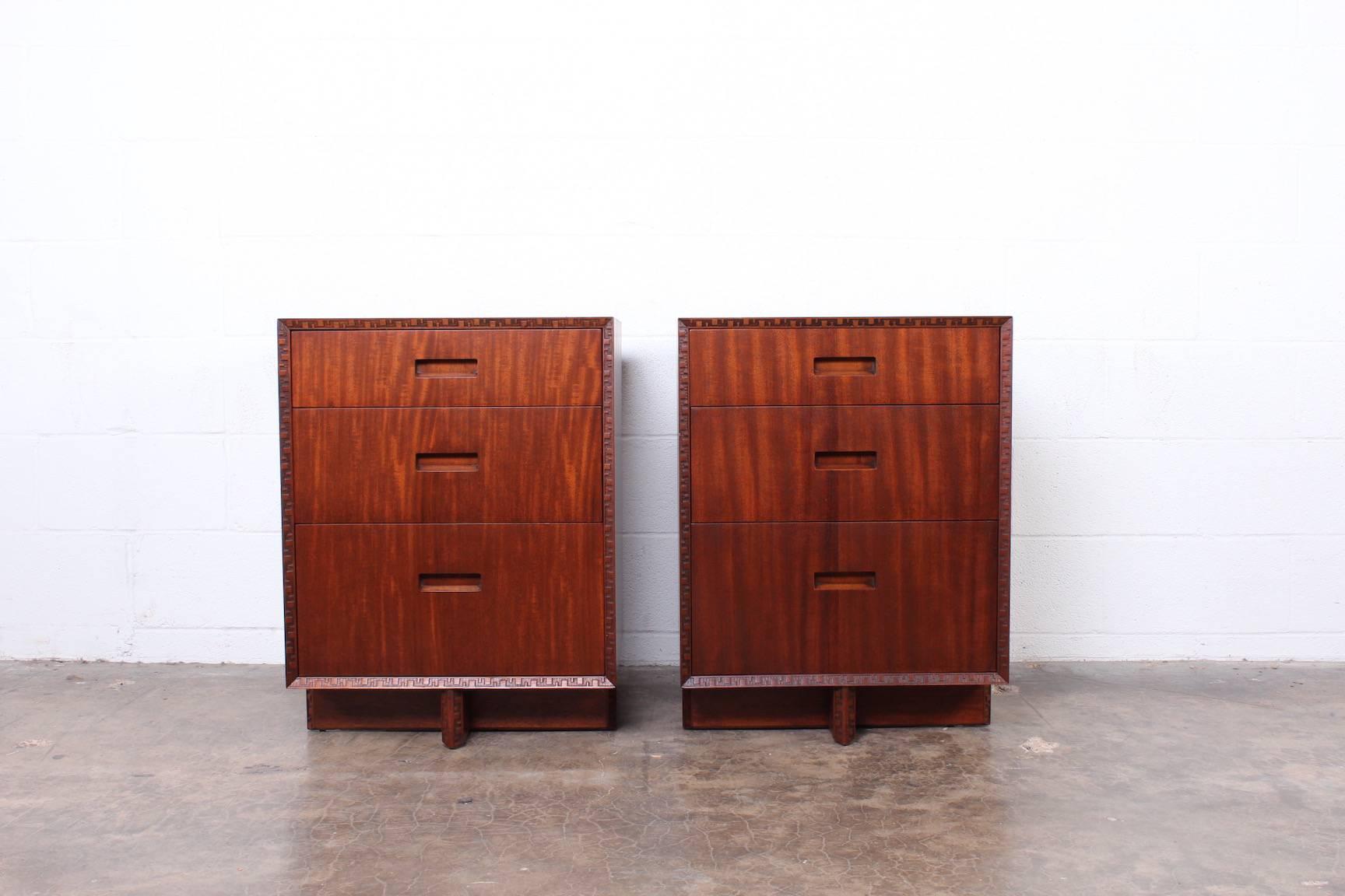 A pair of three-drawer chests / nightstands by Frank Lloyd Wright for Henredon.