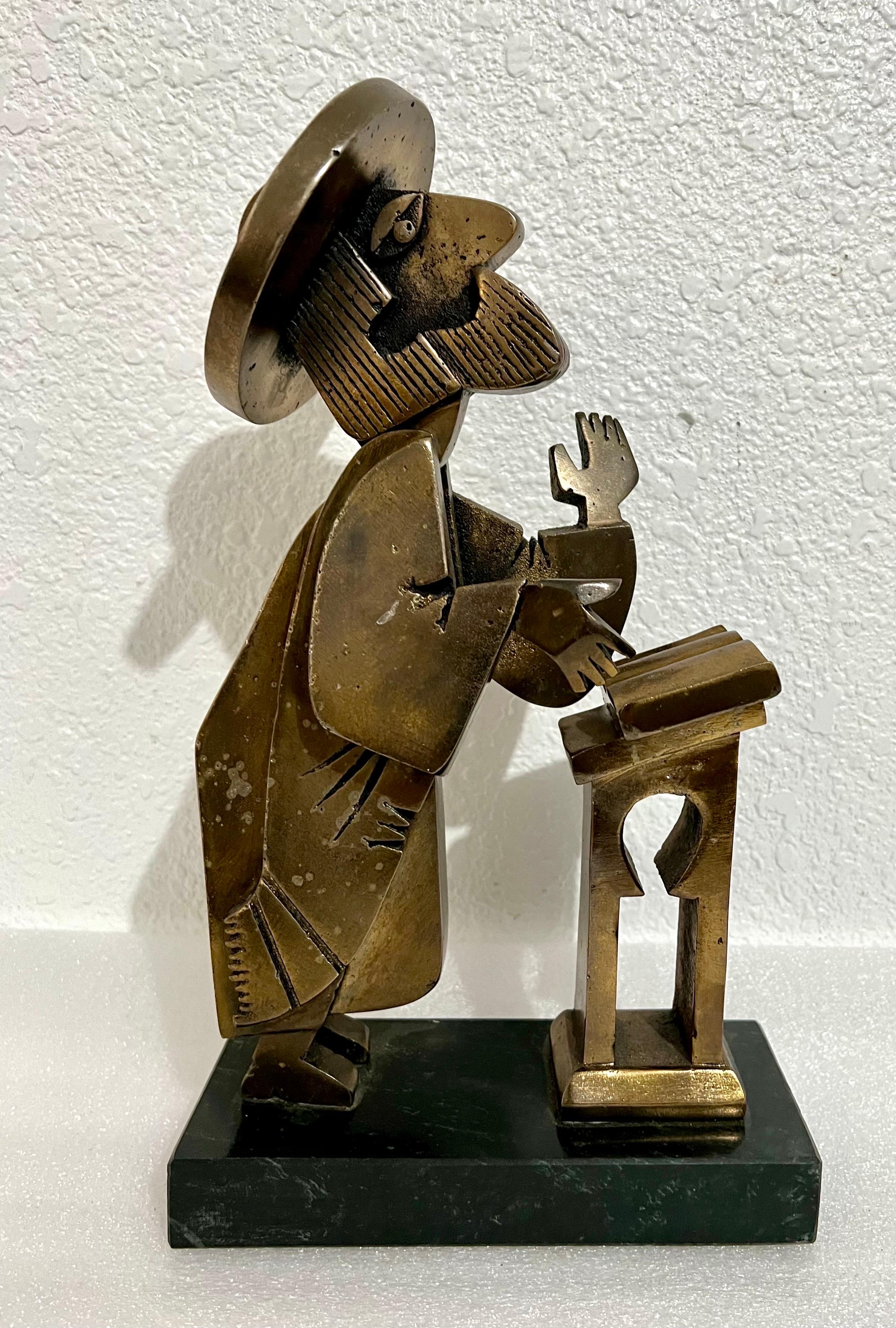 Rare Vintage unusual piece.
In this bronze or metal sculpture by Frank Meisler, the artist recreates a Rabbi at prayer. The figure seems cartoon-like with exaggerated facial features. the head is kinetic and bobs back and forth. you can tilt it back