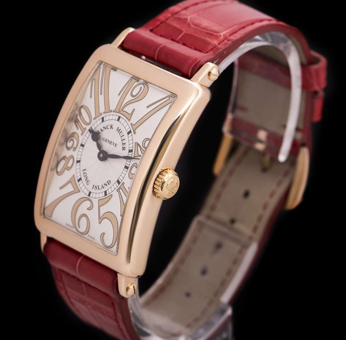 An 18k Rose Gold Long Island Classic Ladies Wristwatch, silver guilloche dial with applied arabic numbers, a fixed 18k rose gold bezel, an original red leather strap with an original 18k rose gold pin buckle, sapphire glass, quartz movement, in