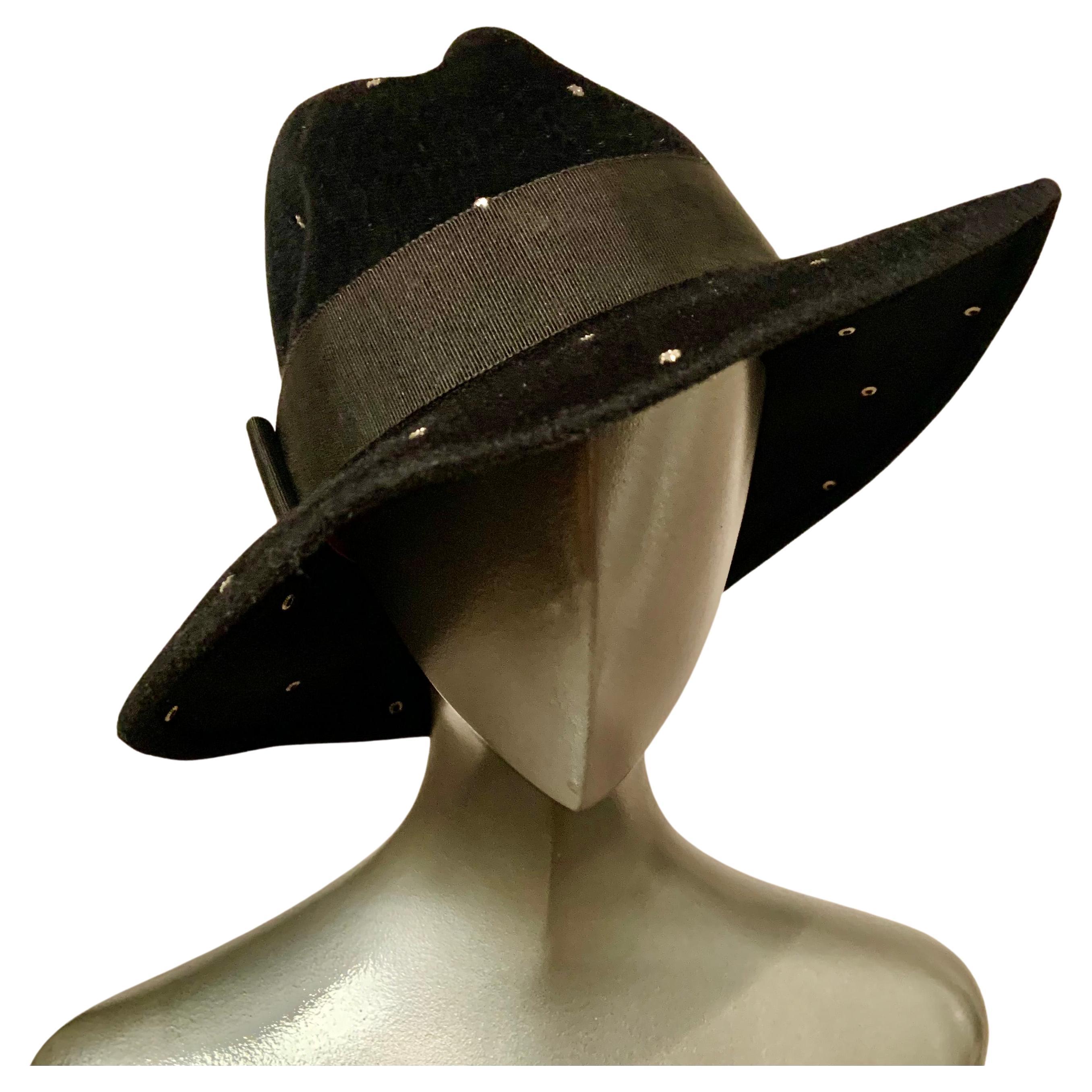 A very chic black wool fedora is studded with rhinestones which add a dash of glamour. The hat also has a black grosgrain ribbon hat band with a flat bow.  It is in excellent condition and the interior circumference is 22