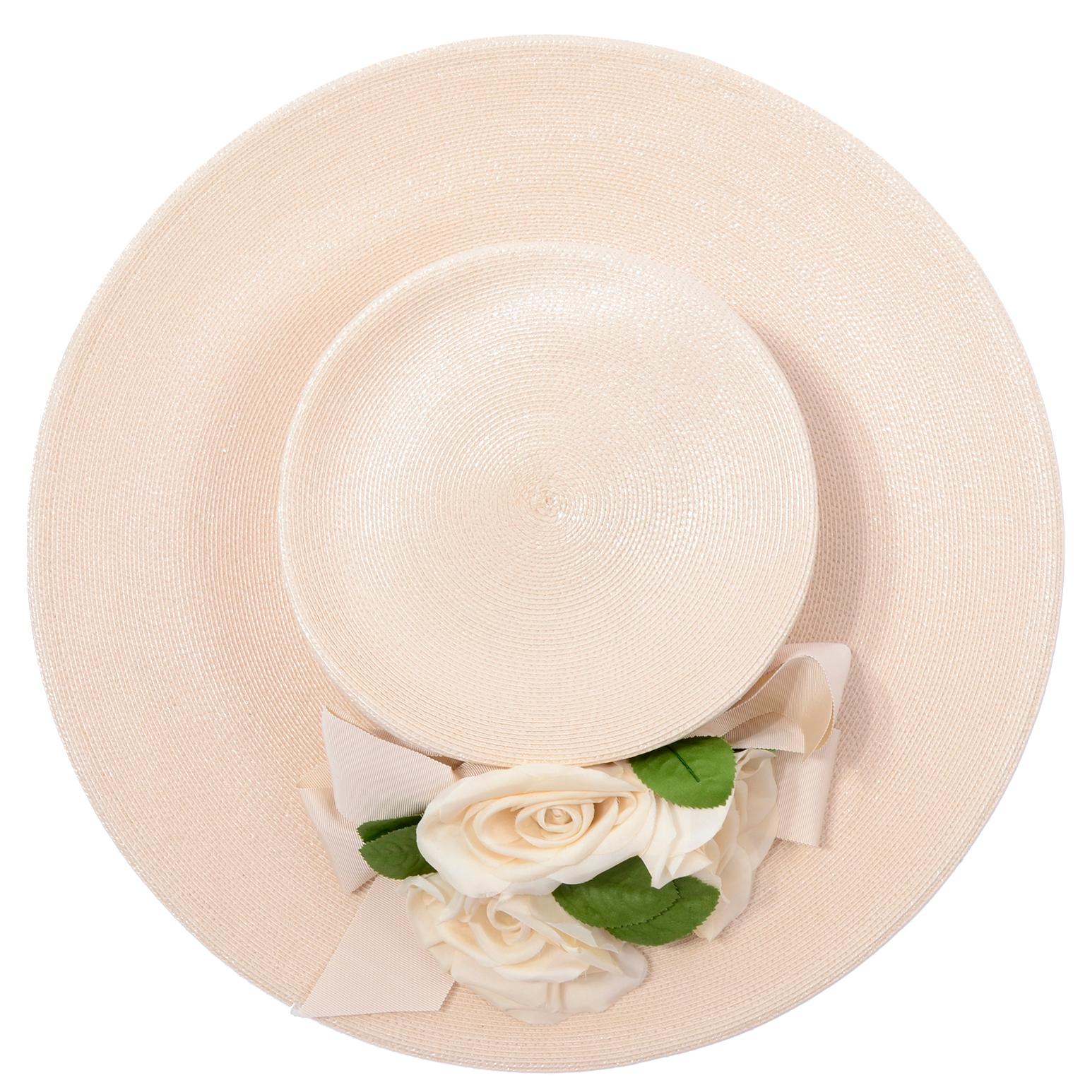 This is a wonderful vintage Frank Olive for Neiman Marcus cream straw hat. The hat has a nice brim with a wide cream bow and three roses with leaves. This pretty hat can be worn with so many different things! Mr. Olive became a milliner when it was