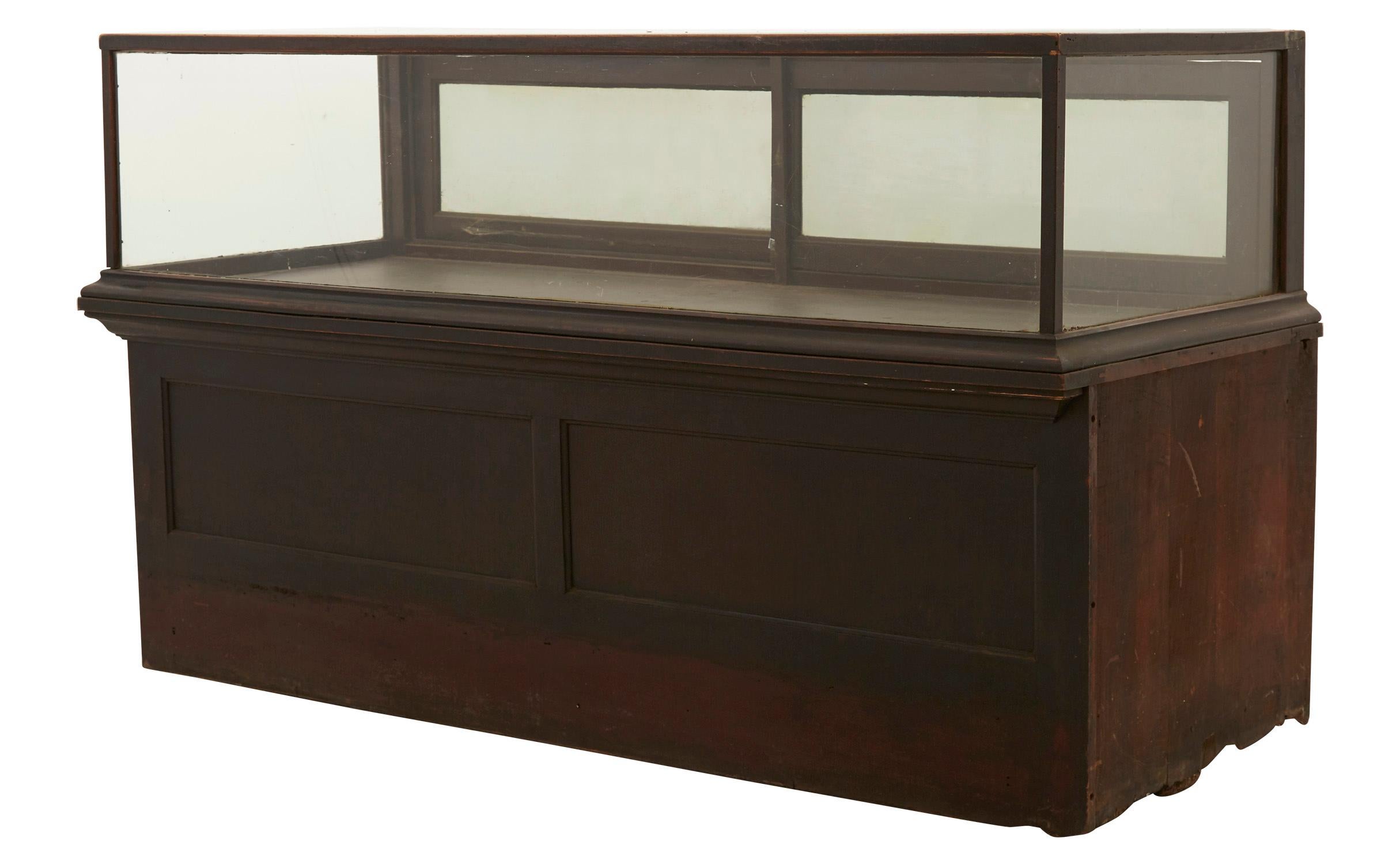 • Salvaged from a general store
• Patinated wood finish
• Original glass
• Mirrored sliding door panels
• 20th century
• American
• Measures 72.25