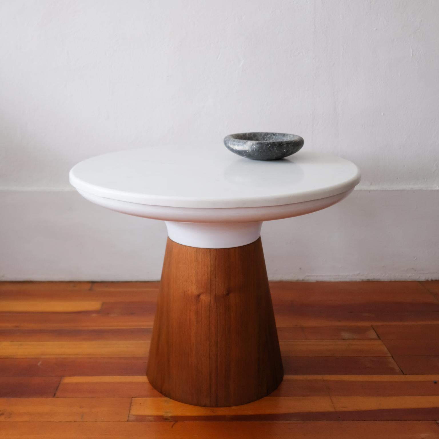 Frank Rohloff pedestal table from the 1960s. The solid white marble top with a rolled edge sits on a formed metal piece and an inverted cone pedestal base is walnut. 

Roholoff was a noted southern California craftsman and furniture designer whose