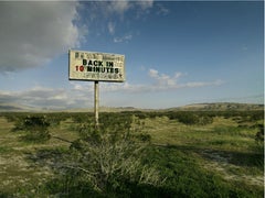 Used Back in 10 - large format photograph of conceptual message sign in landscape