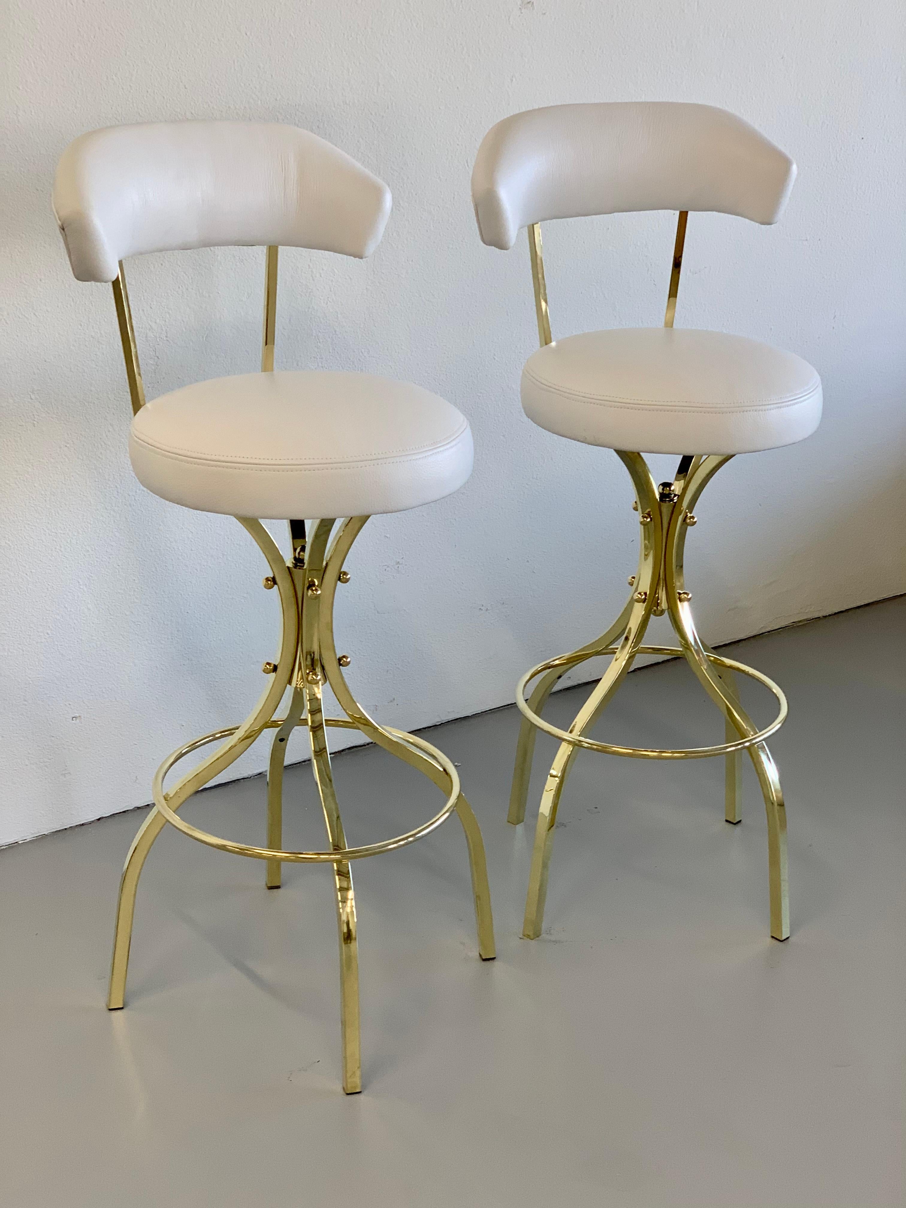 A vintage pair of brass and leather bar stools by Charles Hollis Jones. These are his 