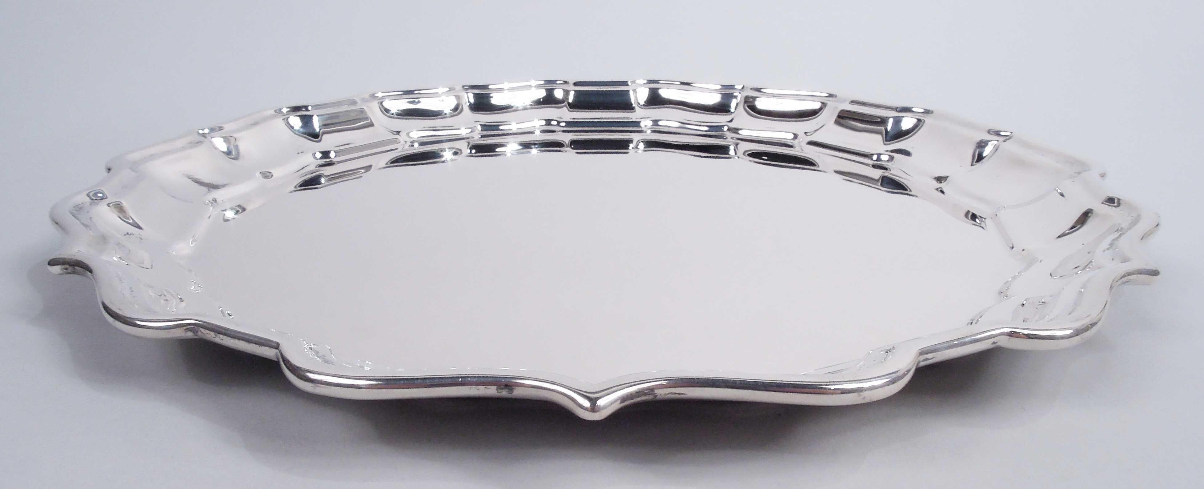 Chippendale sterling silver tray. Georgian-style sterling silver serving tray. Made by Frank Smith in Gardner, Mass. Round with molded curvilinear ogee piecrust rim. Traditional Georgian in the aptly names pattern. Fully marked including maker’s