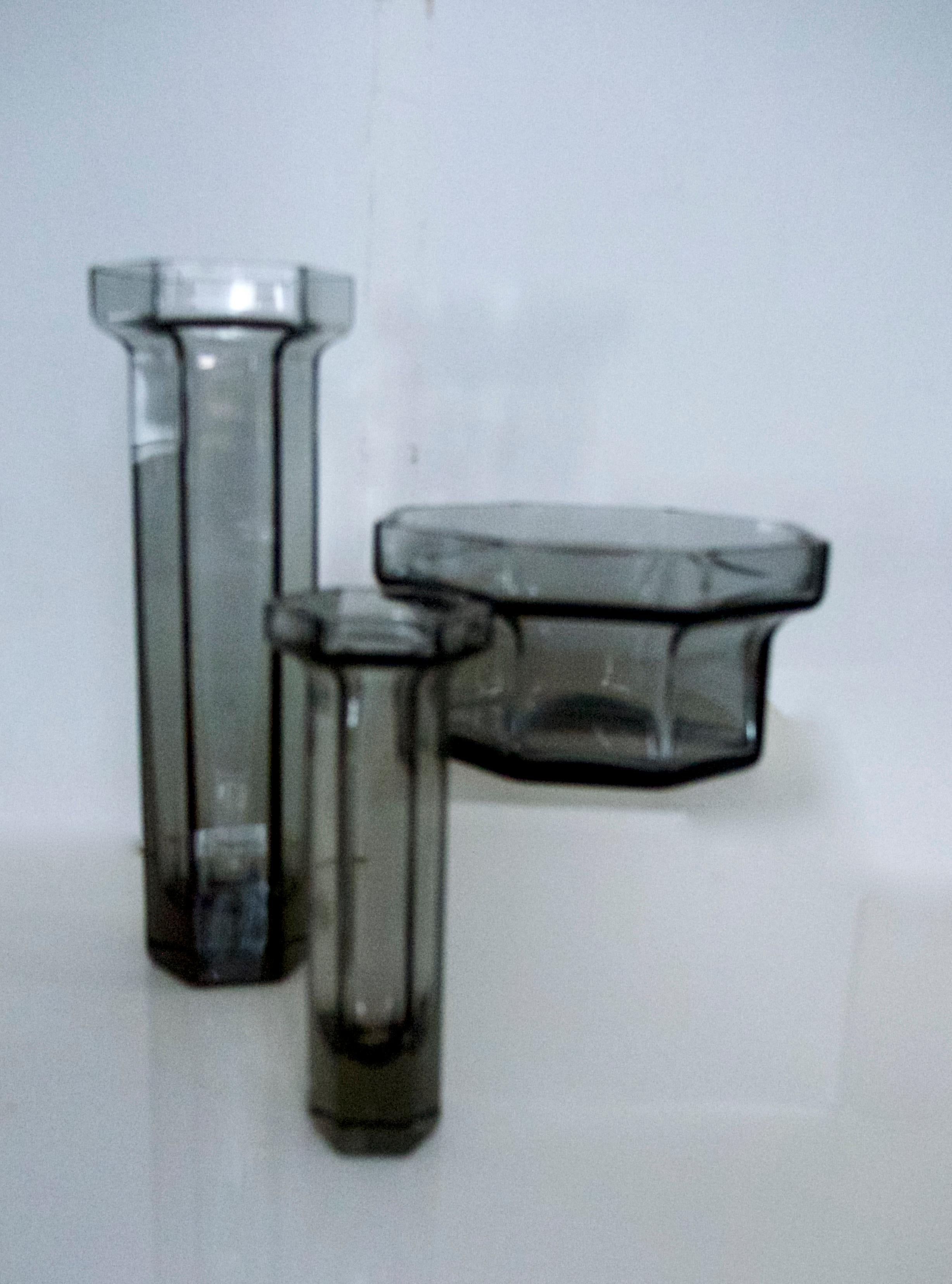 Modernist Frank Thrower three-piece glass candleholders 'BRUTUS' collection Wedgewood, 1970.

Measures: Large candleholder - six sides
Height 25 cms
Diameter 9 cms
Weight 0.0996 kgs

Small candleholder - six sides
Height 16 cms
Diameter