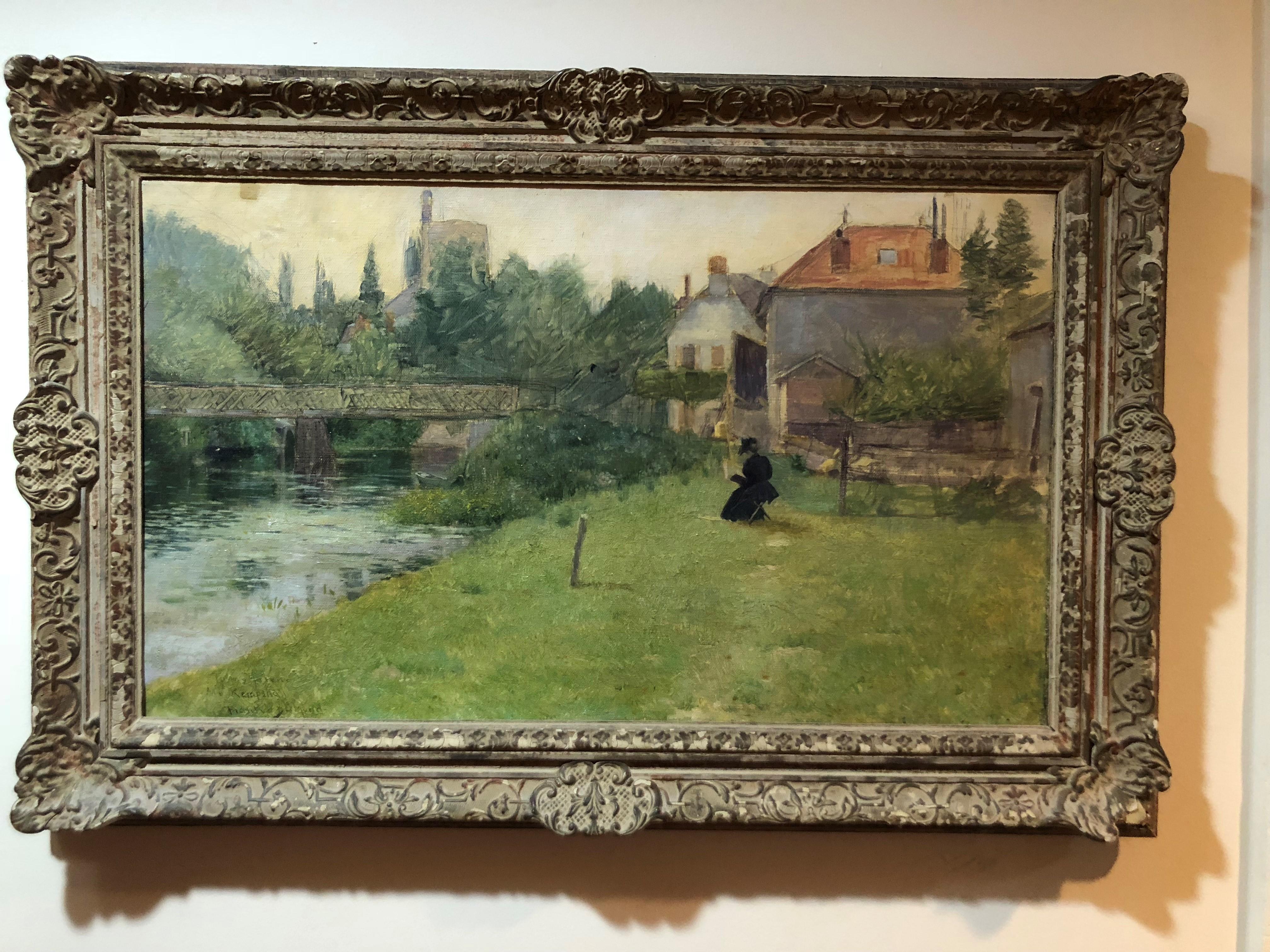 Frank Vincent DuMond painting. Bucolic setting of a woman in a pastoral scene by a river. She is seated reading and dressed in an Edwardian, early 20th century clothing. Signed lower left. 