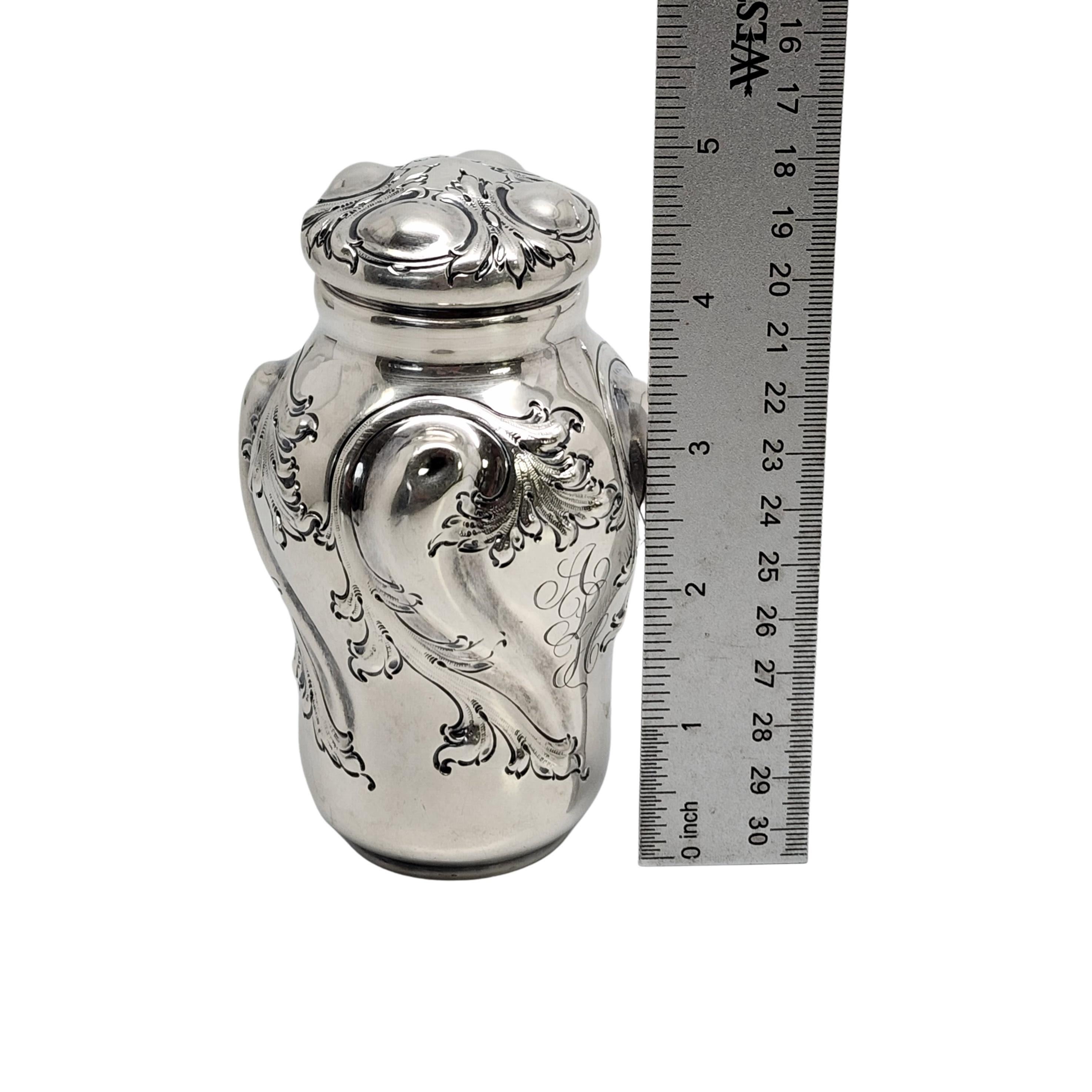 Sterling silver tea caddy by Frank W. Smith for Theodore B Starr of NY, NY with monogram.

Monogram appears to be APH

Bulbous shape with repousse scroll design on sides and on the lid. Ornate monogram on one side.

Measures approx 4 3/4