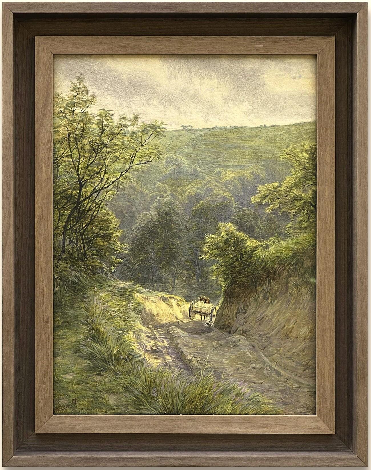 This atmospheric watercolour by Frank Walton, dated 1867 and signed lower left, reflects the artist’s technical skill and sensitivity in capturing the British countryside. Depicting a rural sandy path winding through dense woodland, the composition