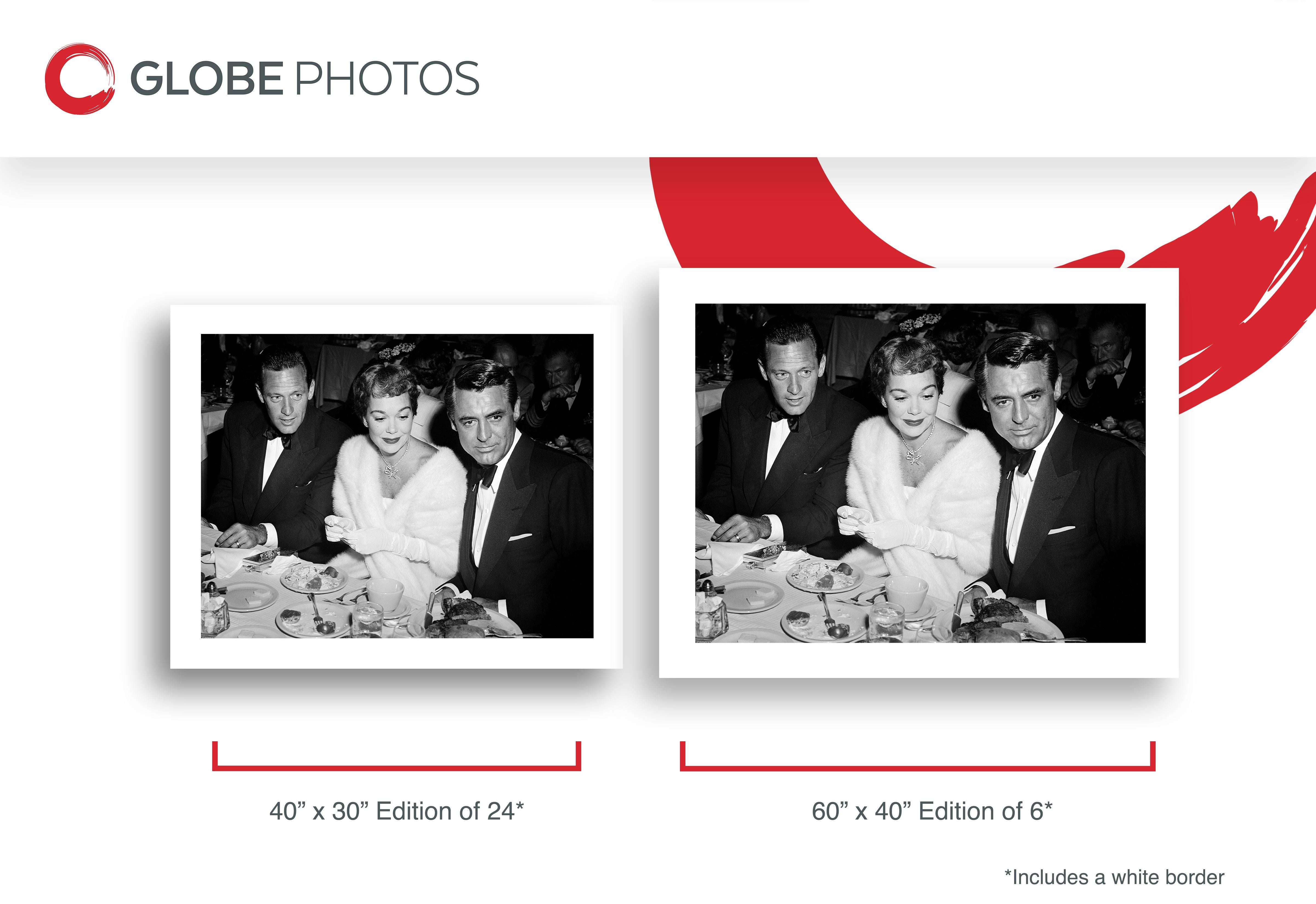 Black and white candid portrait of Cary Grant, Jane Wyman, and William Holden sitting at the table, 1951.
 
 Cary Grant was an English-American actor. Known for his mid-Atlantic accent, debonair demeanor, light-hearted approach to acting, and sense