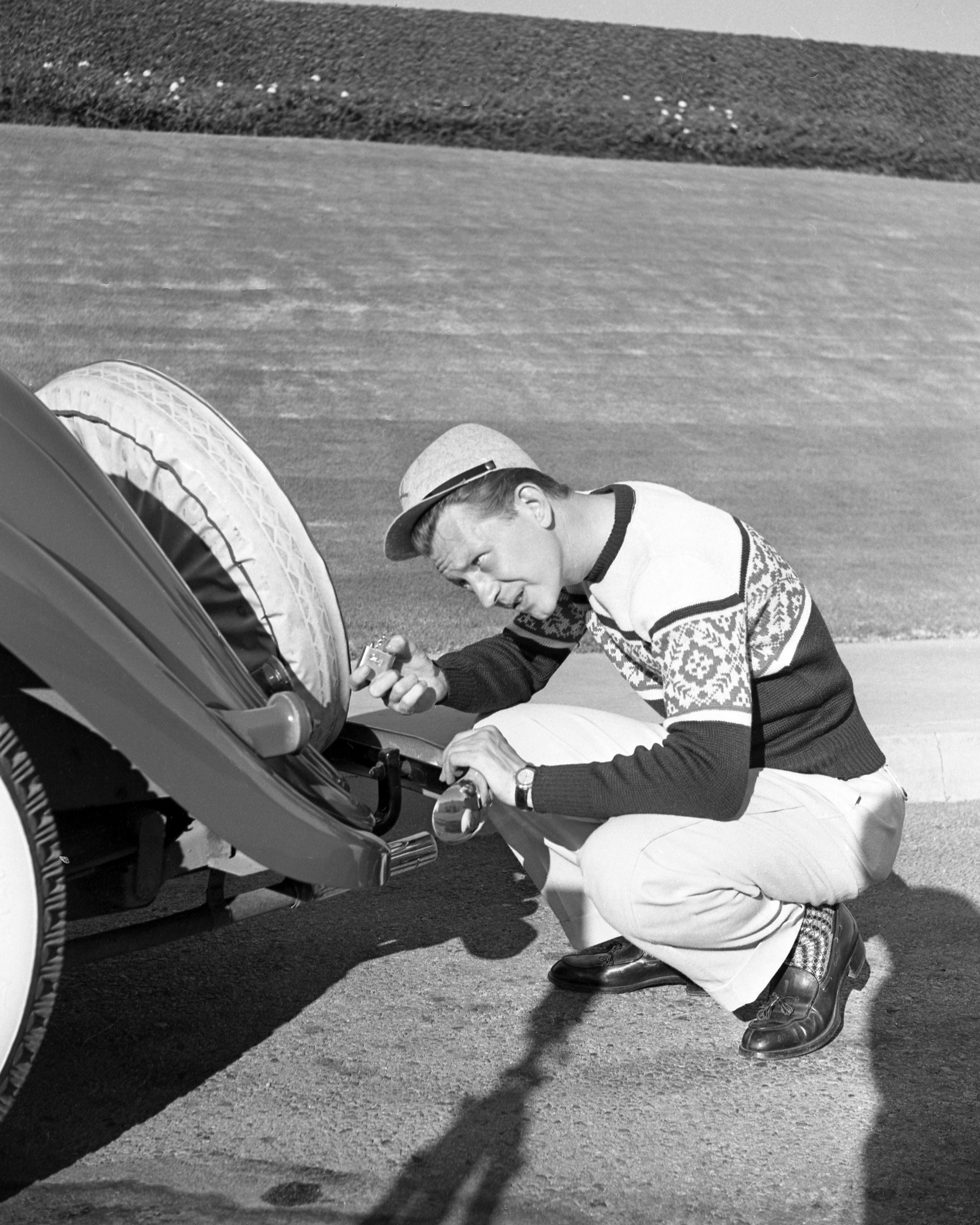 Frank Worth Black and White Photograph - Donald O’Conner Fixing Car