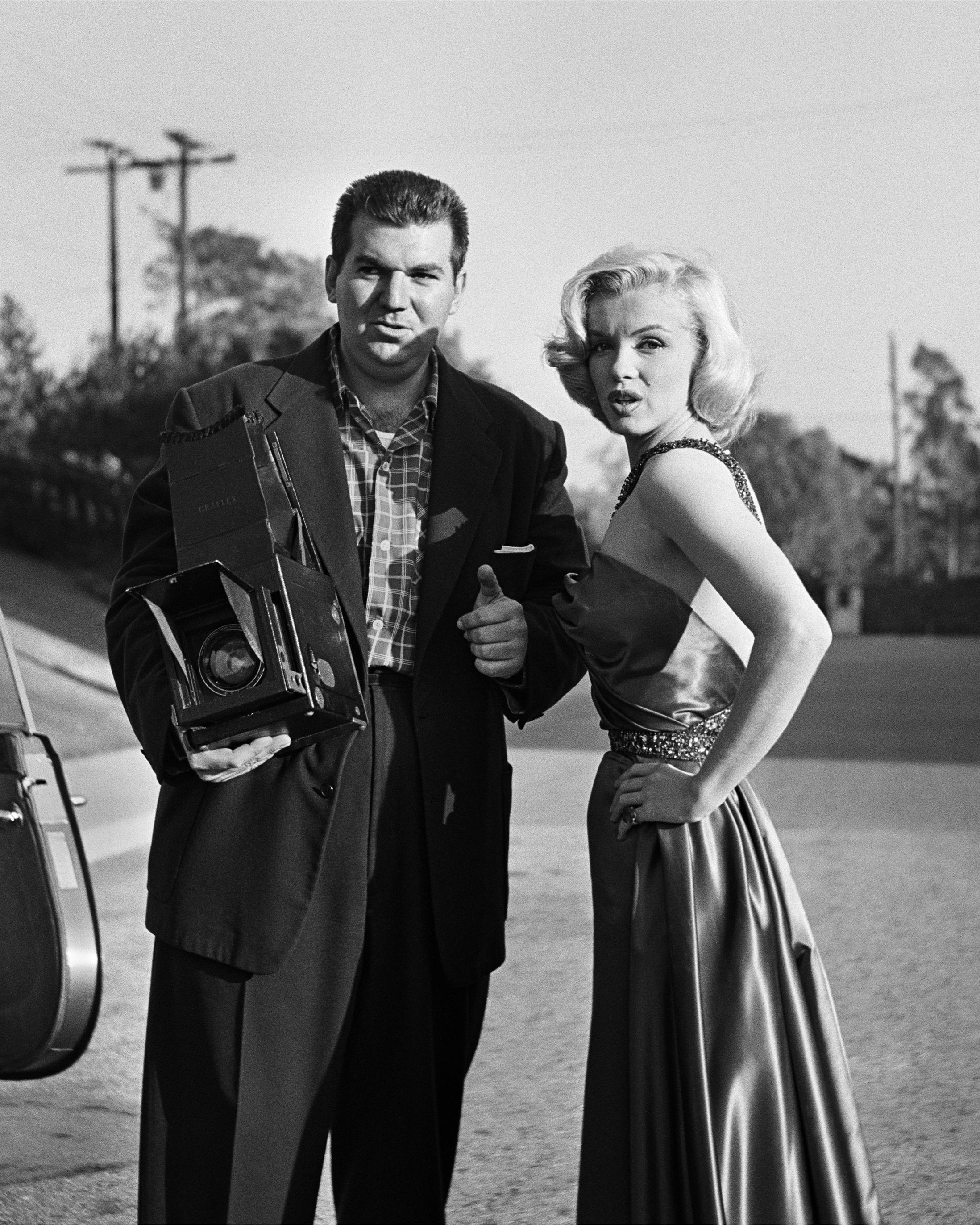Black and White Photograph di Frank Worth - Marilyn Monroe in piedi con un fotografo