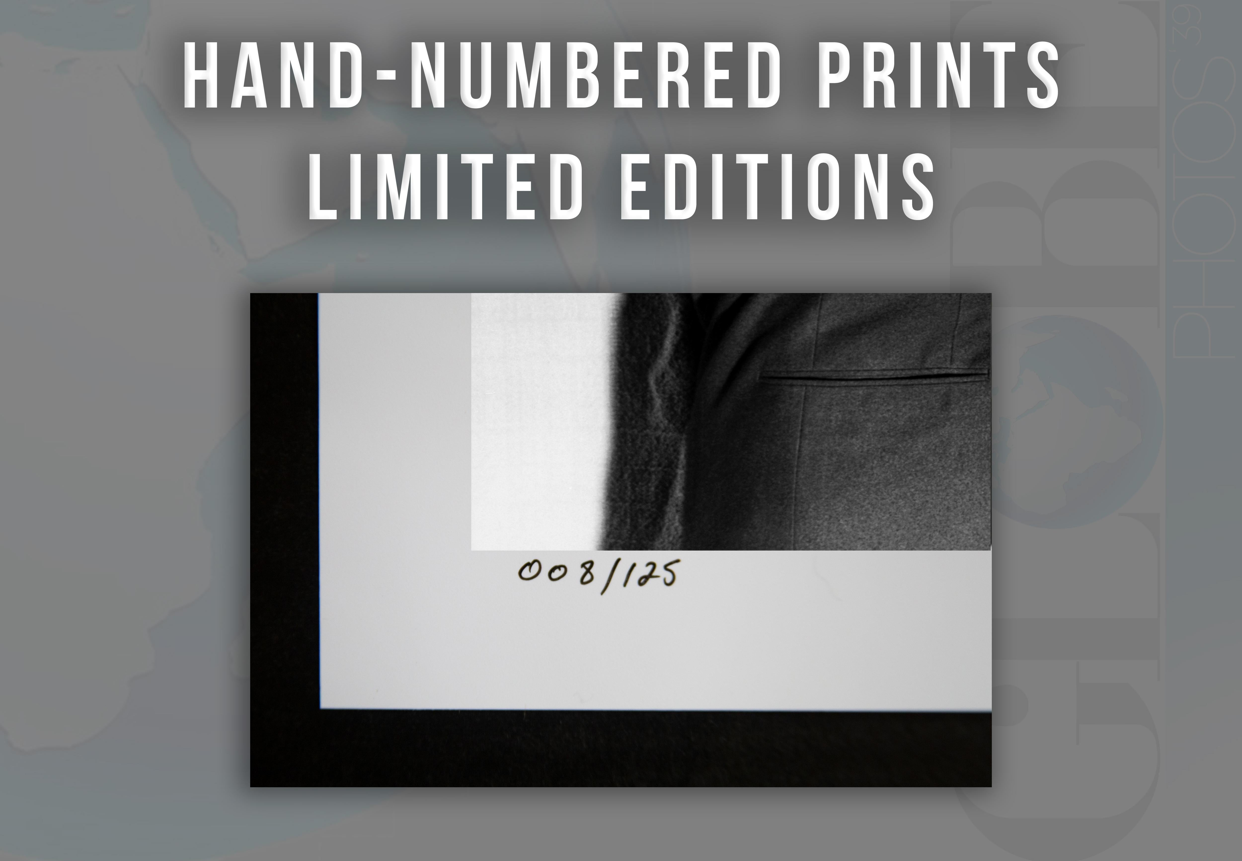 This black and white portrait by photographer Frank Wort features Alan Ladd & Humphrey Bogart in suits grabbing one another.

This image is credited to Globe Photos.

This is a limited edition fine art C-Print, hand numbered out of an edition of 125