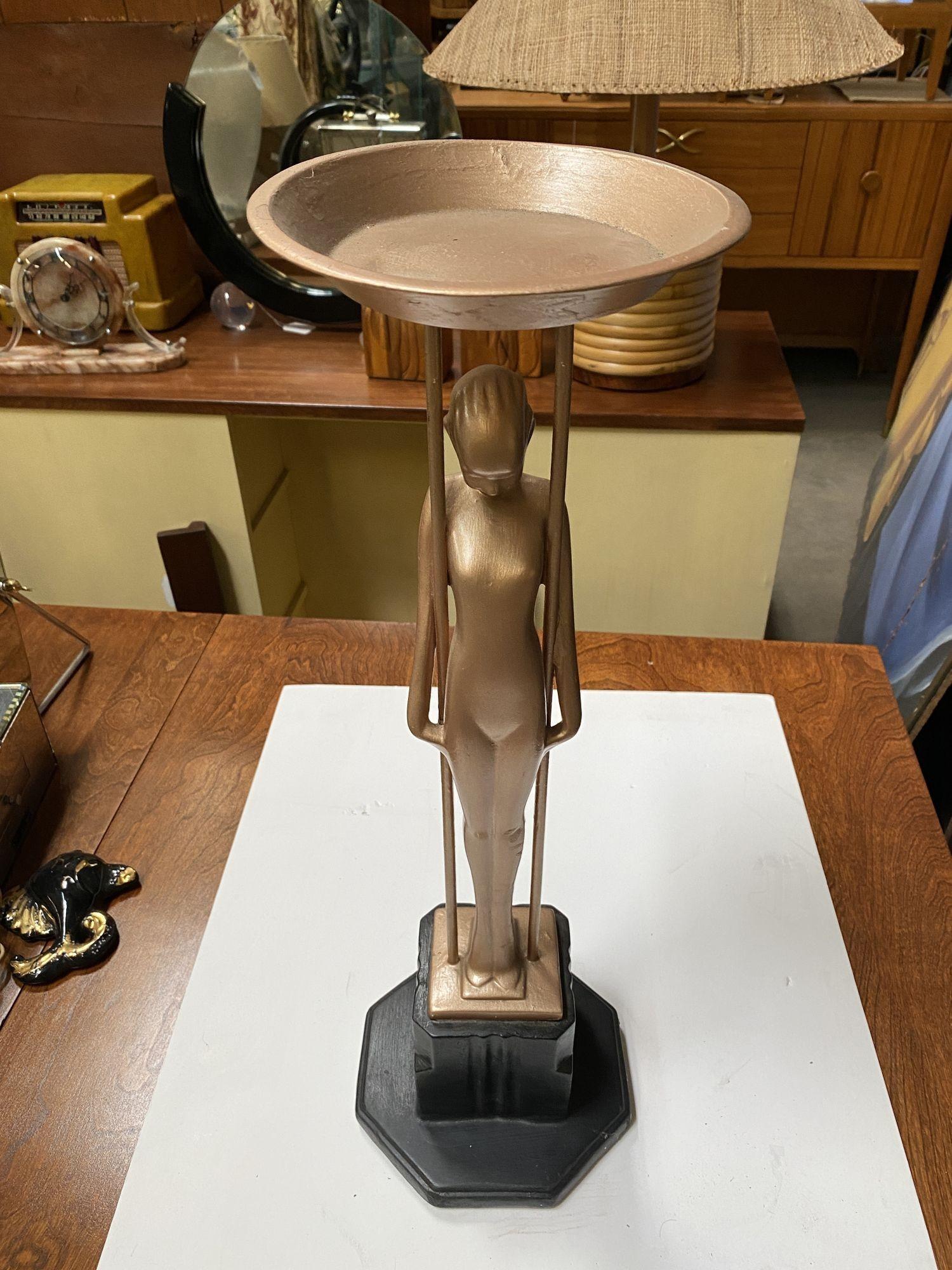 Frankart company figural “Sarcophagus Girl“ metal ashtray stand featuring a nude women holding up the ashtray stand standing on a stepped art deco base. 

Frankart # T349, patent # 85411 by Max Abel 1931.
 
Dimensions: 27.5