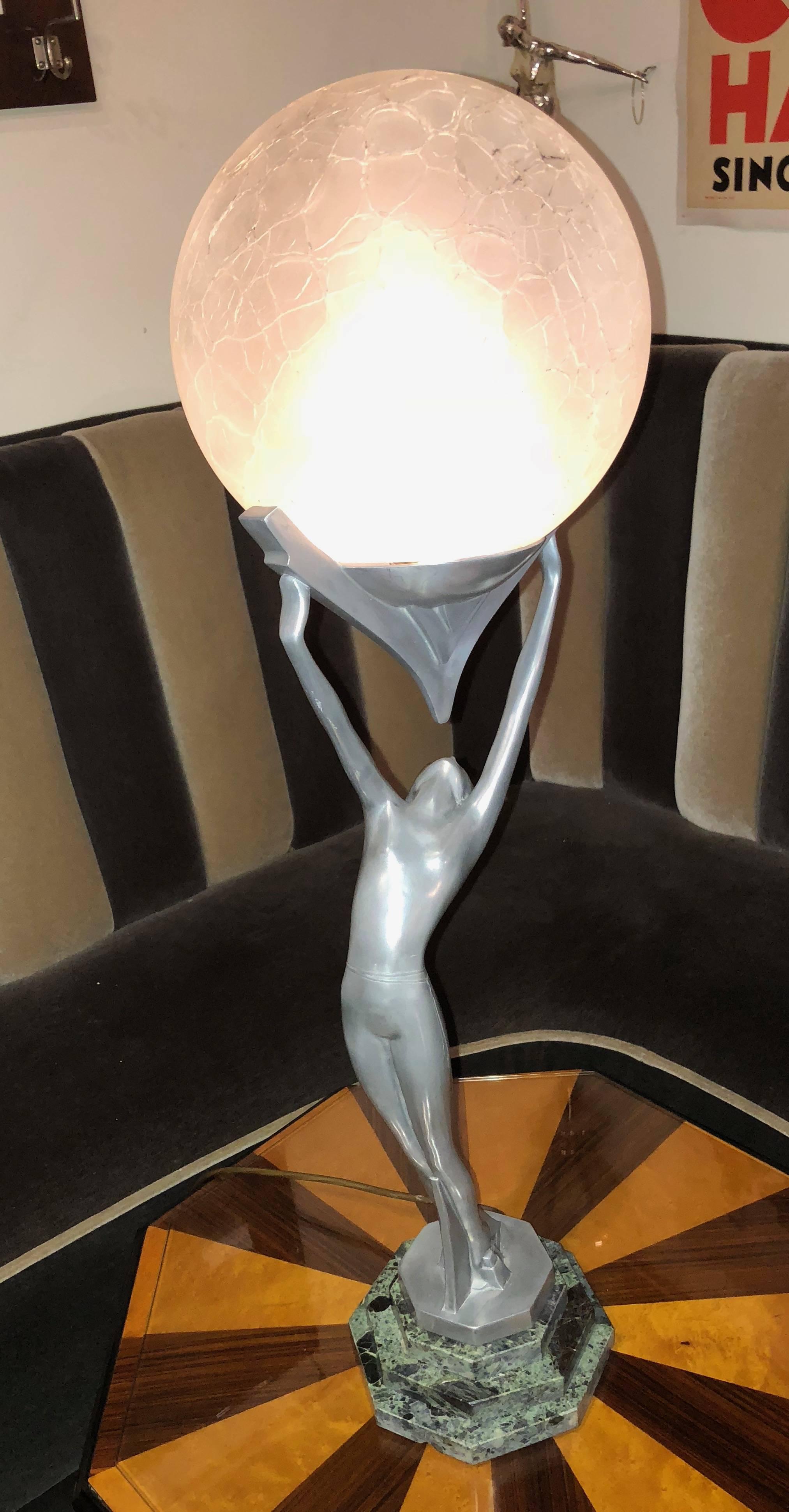 Frankart lamp of a nude stylized figure holding a glass globe on stepped marble base. This rare and unique piece may be just one of kind, a pro-type designed but never commercially or widely produced. It is a stunning figure standing 30 inches tall