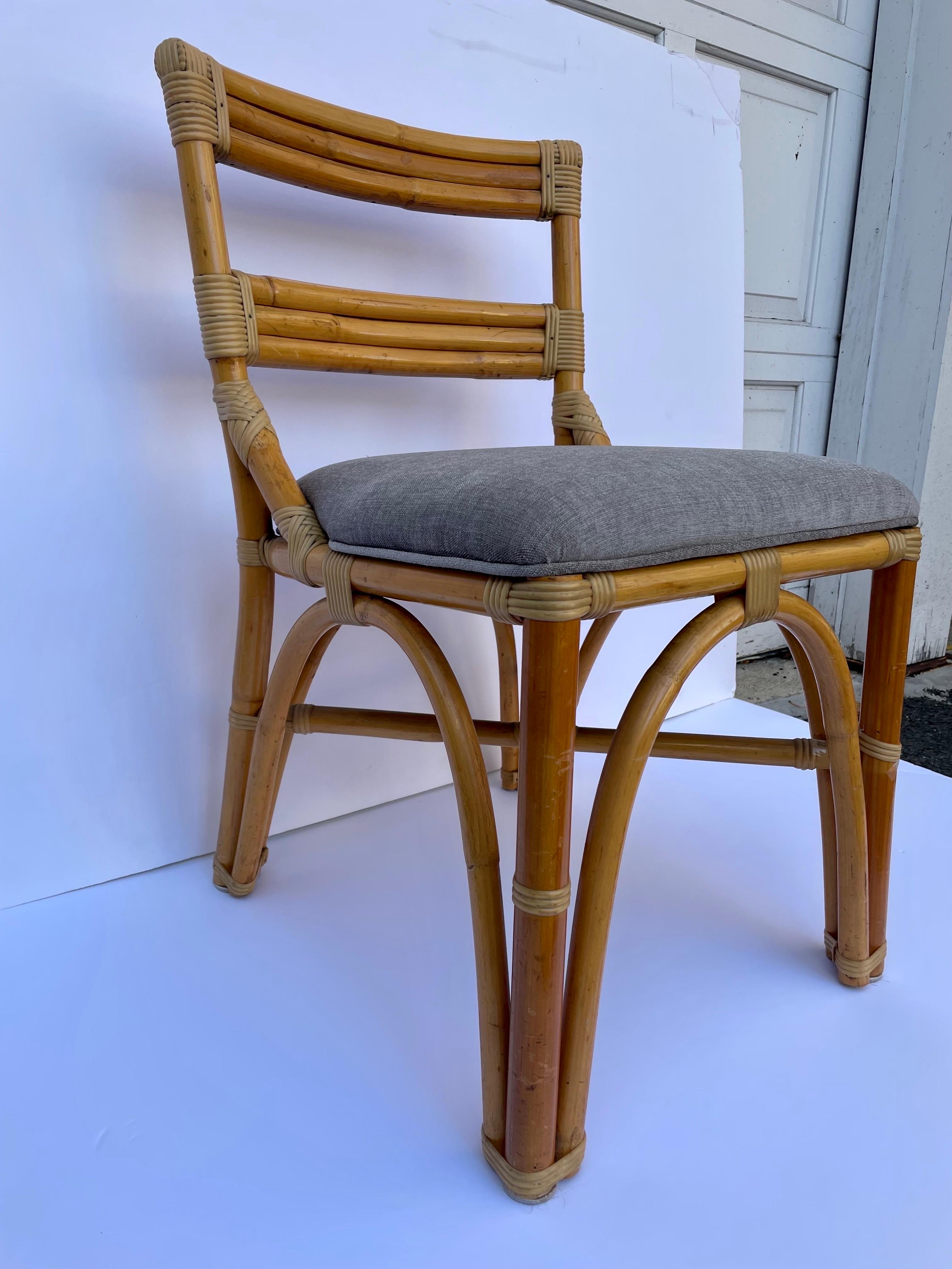 Paul Frankl style arched base bamboo side or desk chair with new grey chenille upholstery. Slight wear to frame finish from age appropriate wear and use.