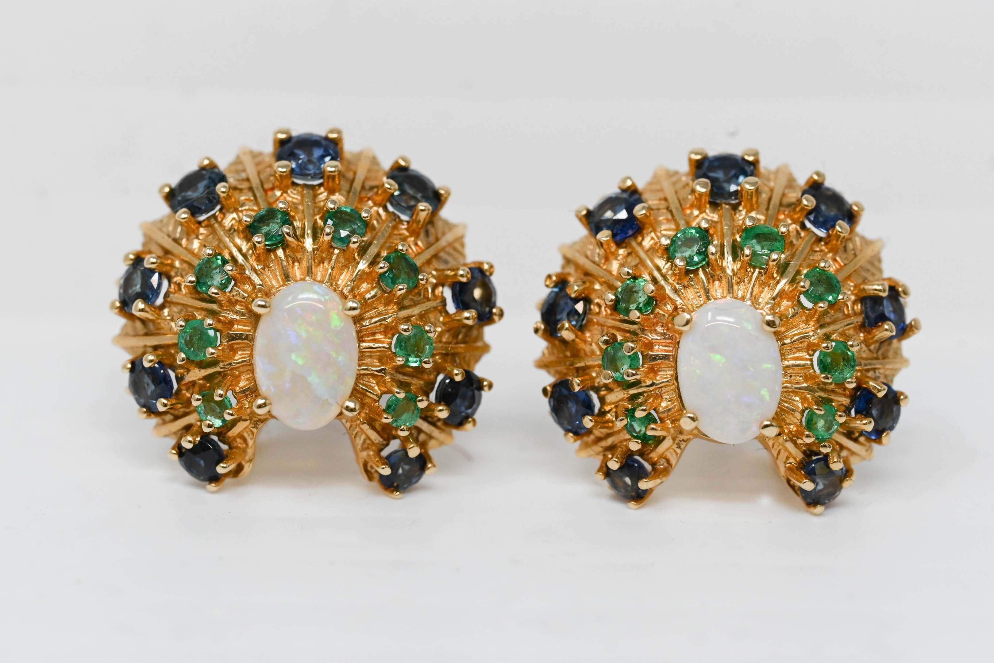 Franklin Mint 1989 14k gold 5 x 7 mm opal, emeralds and sapphires gemstone. Peacock design earrings with screwed post. Stamped on the back, F.M. 89. 14k weighs 9.6 grams. Maker mark is Franklin Mint.
