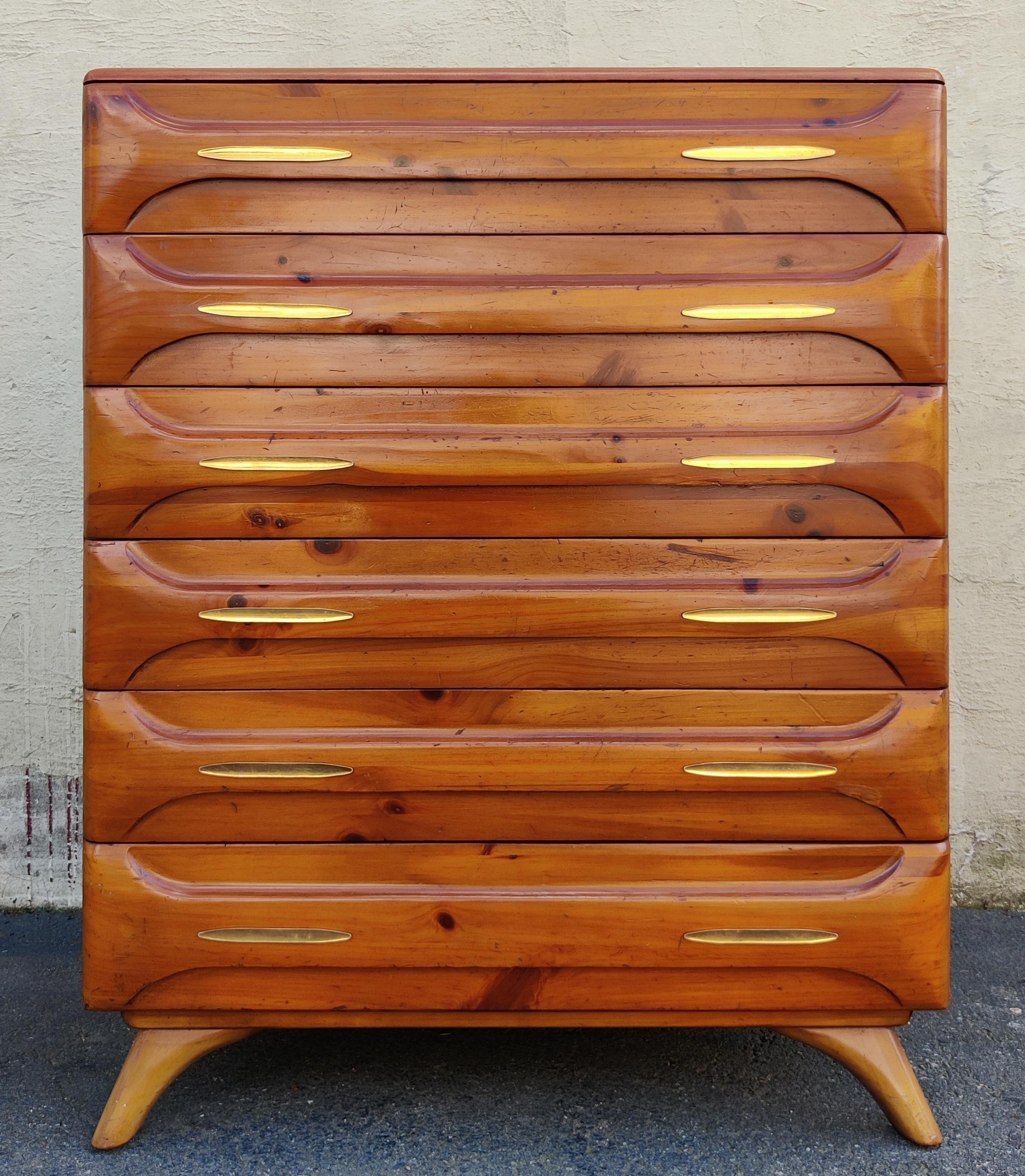 This tall dresser was produced in the 1970s by the Franklin Shockey Company for their Sculptured Pine line of furniture. Featuring solid pine construction, this dresser has a light and warm golden pine color with satin varnished finish. This color