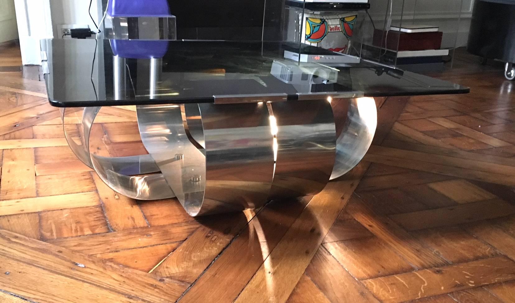 A rare François Monnet polished steel and smoked glass coffee table, each side formed with a double curved sheet of polished steel.
The original smoked grey glass top and base have few tiny small scratches typical of use.
  
Size is 90 x 90 cm