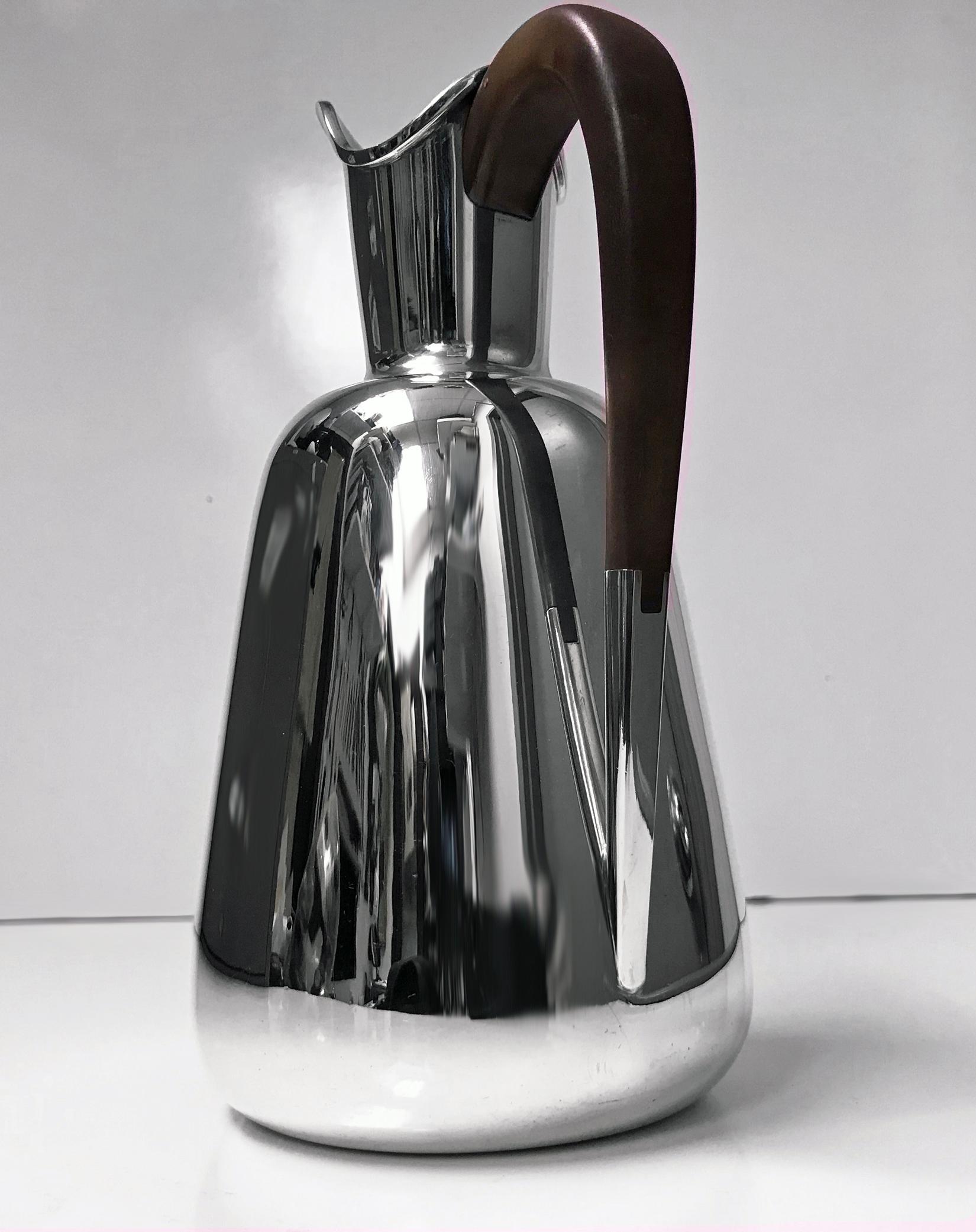 Frantz Hingelberg sterling water jug pitcher Aarhus, circa 1940. Elegant midcentury plain design with ebony handle. Height: 7.75 inches. Item weight: 470 grams. Stamped F.Hingelberg Aarhus sterling Denmark 925S Crown mark above and E design within