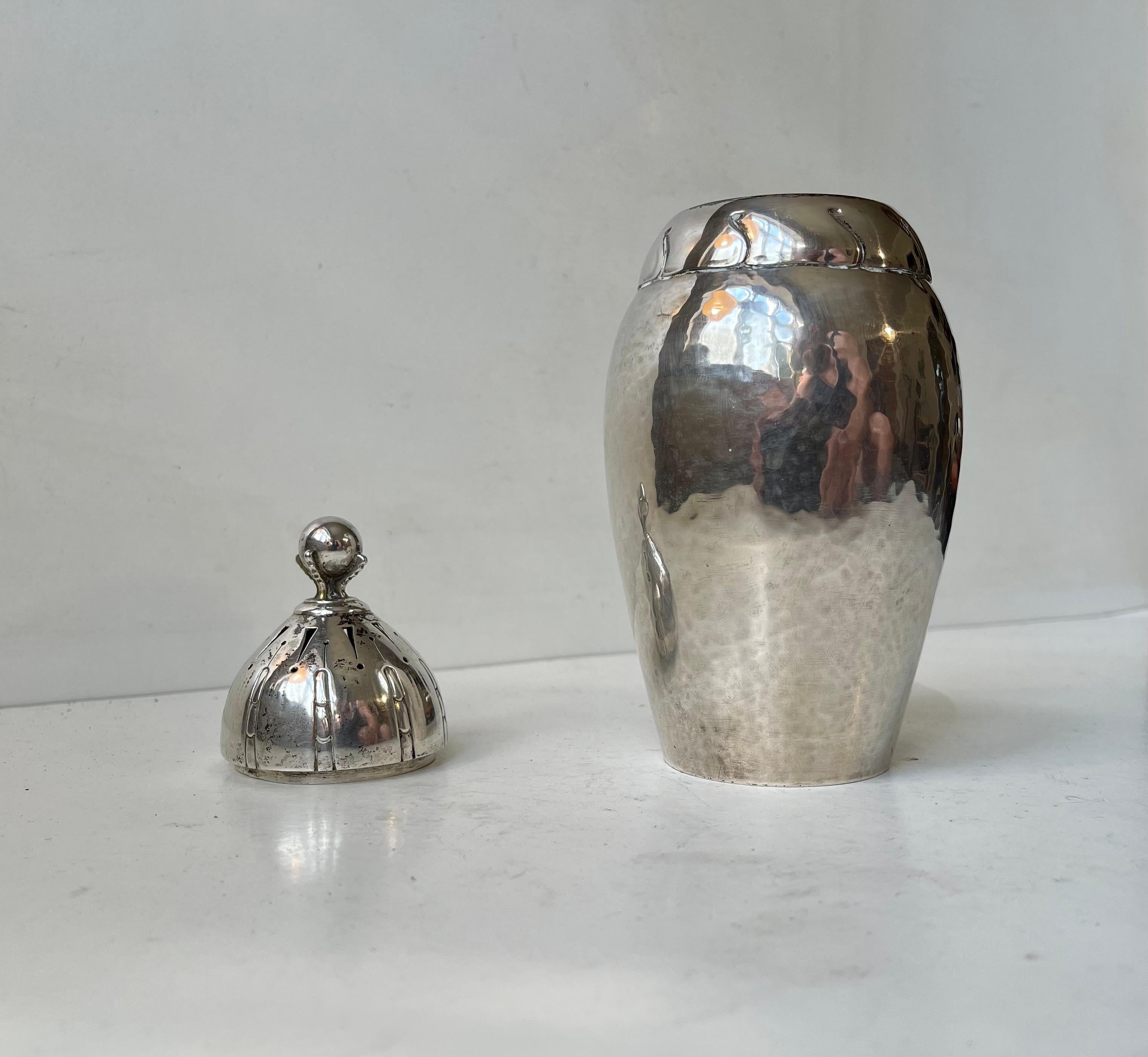 Ornate large sugar caster for strawberries, pancakes etc. Its fashioned from delicately hammered solid silver indicated by the 3 towers to its base. Subtle jugend styling and topped with a birds or dragons claw holding a sphere or globe - a symbol