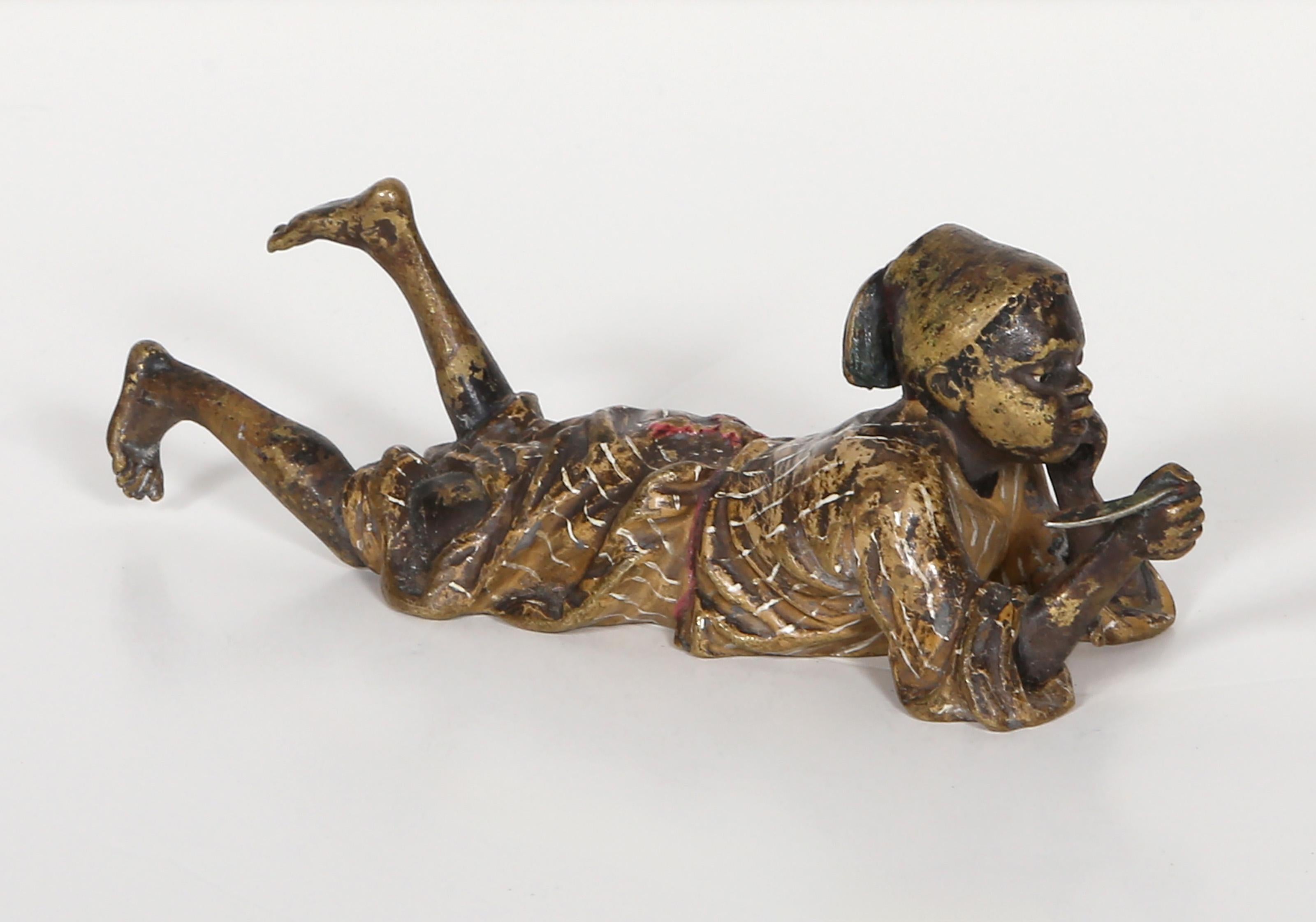Franz Bergmann, Austrian (1861 -1936) - Boy Smoking Pipe, Year:  circa 1900, Medium:  Cold painted Bronze sculpture, Size:  2 x 6 x 2 in. (5.08 x 15.24 x 5.08 cm)