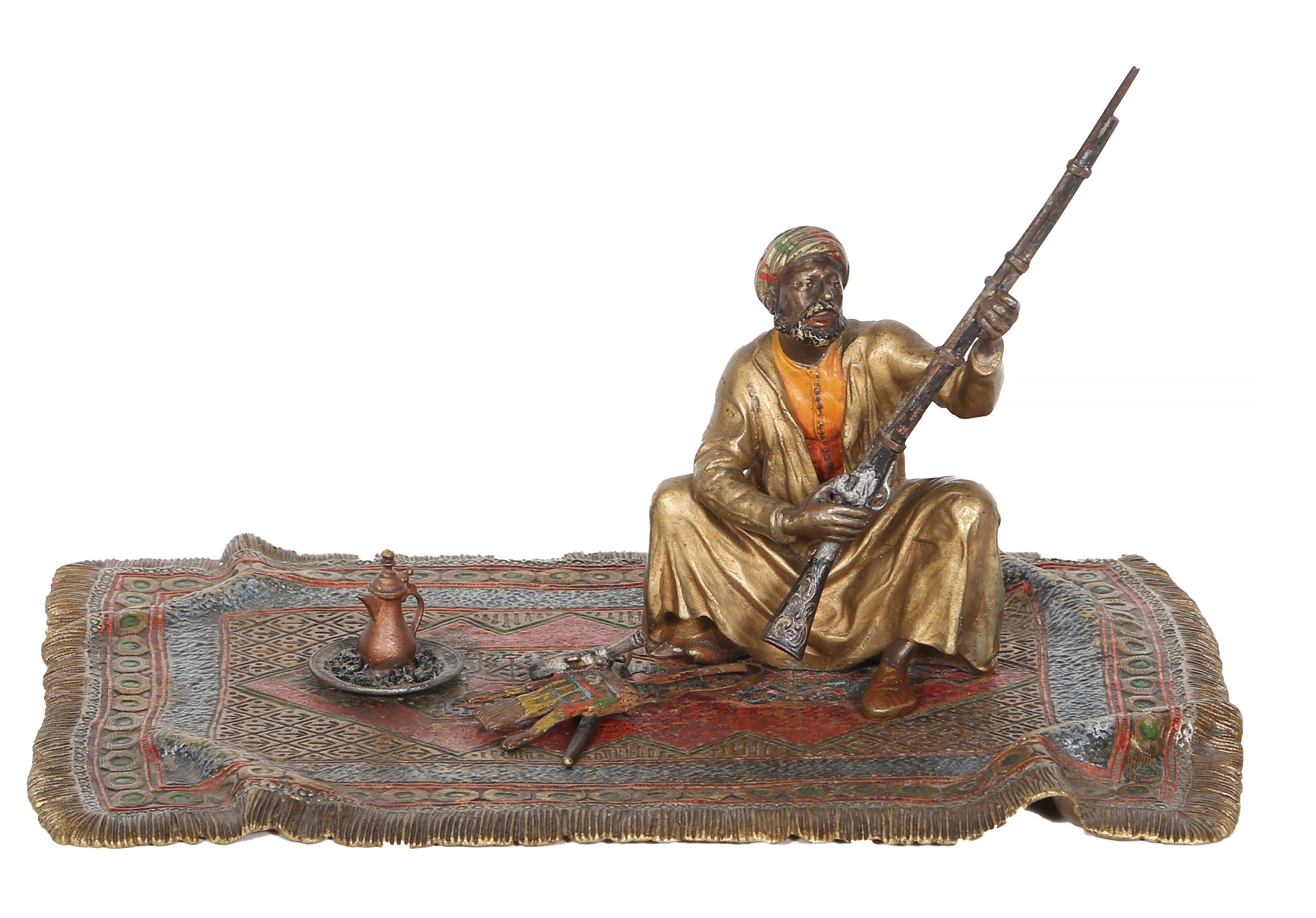 Franz Bergmann, Austrian (1861 -1936) - Man on Persian Rug, Year:  circa 1900, Medium:  Cold painted Bronze sculpture, stamp signed on bottom, Size:  4.5 x 10 x 7 in. (11.43 x 25.4 x 17.78 cm), Description:  "Made in Austria" inscribed on bottom