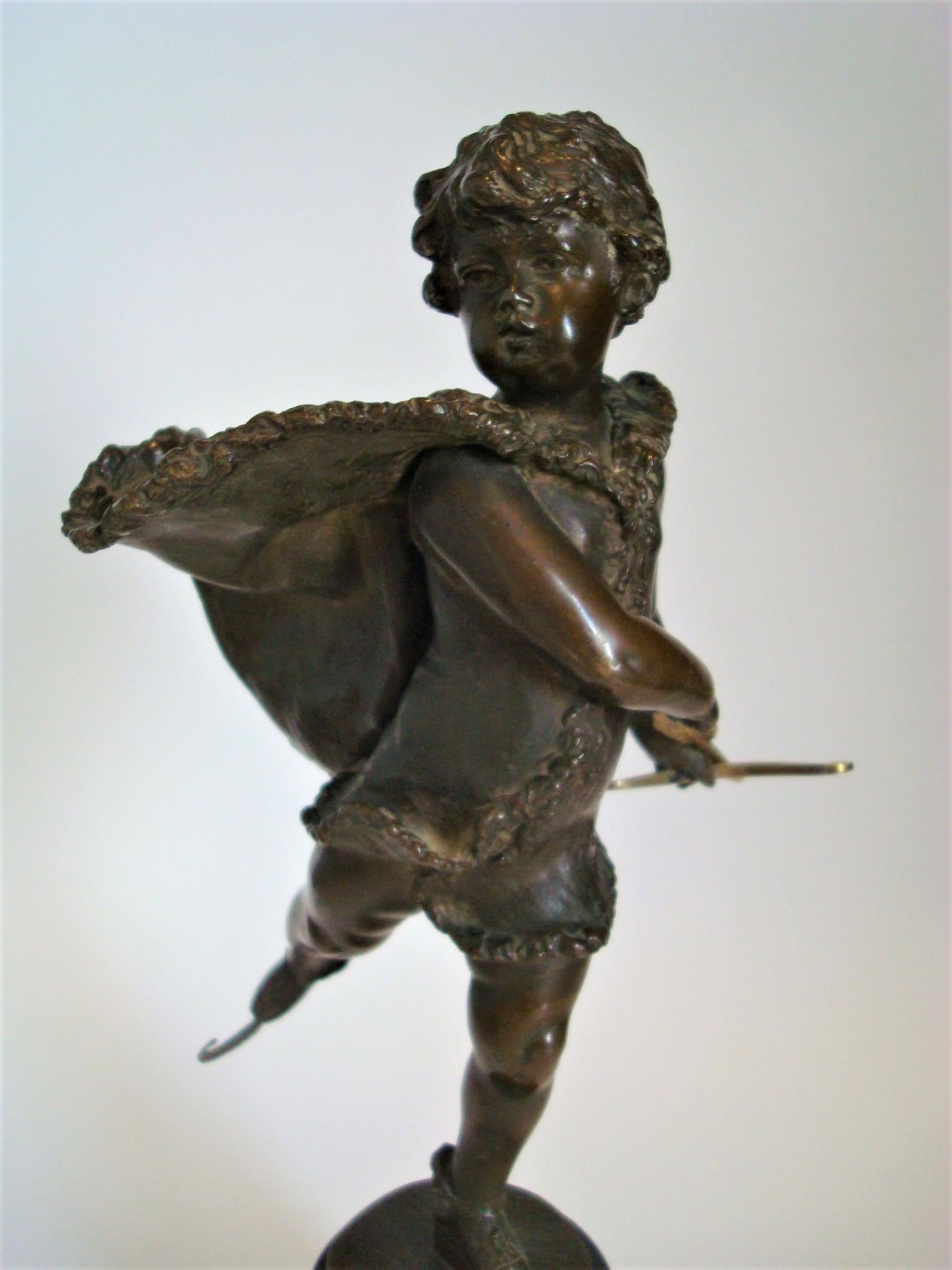 Bronze depicting a young boy (cupid) ice skating, by Franz Iffland (Berlin 1862-1935). A boy in fur-trimmed cape, holds a cupid-like feathered arrow with bow. Iffland was a member of the Berliner Bildhauerschule, was active 1885-1915. He became most