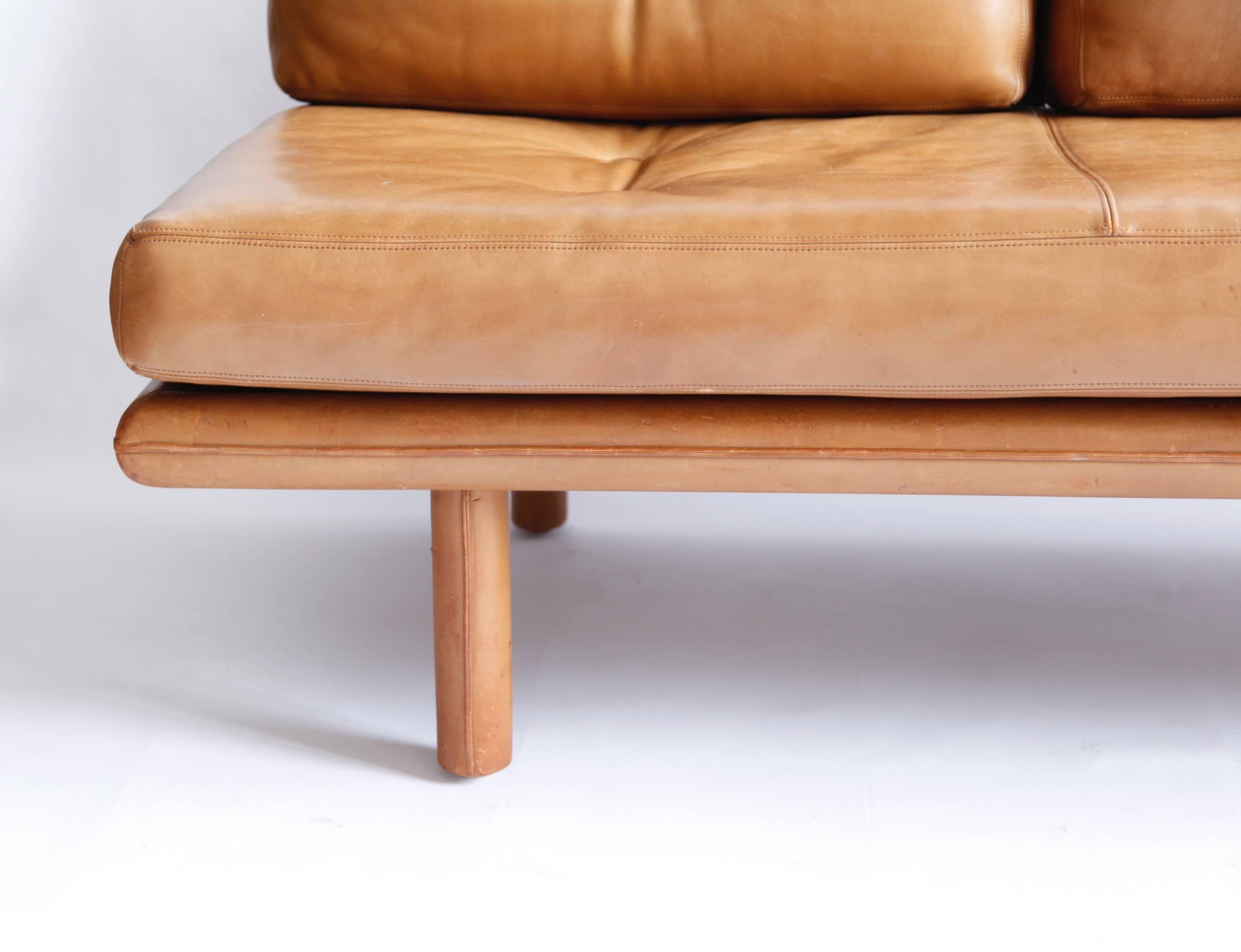 A simple and wonderful design from the 1960s produced by Kill International, a furniture maker of outstanding quality. Three leather cushions can be removed to form a very comfortable single bed. Base and legs are wrapped in leather also. All