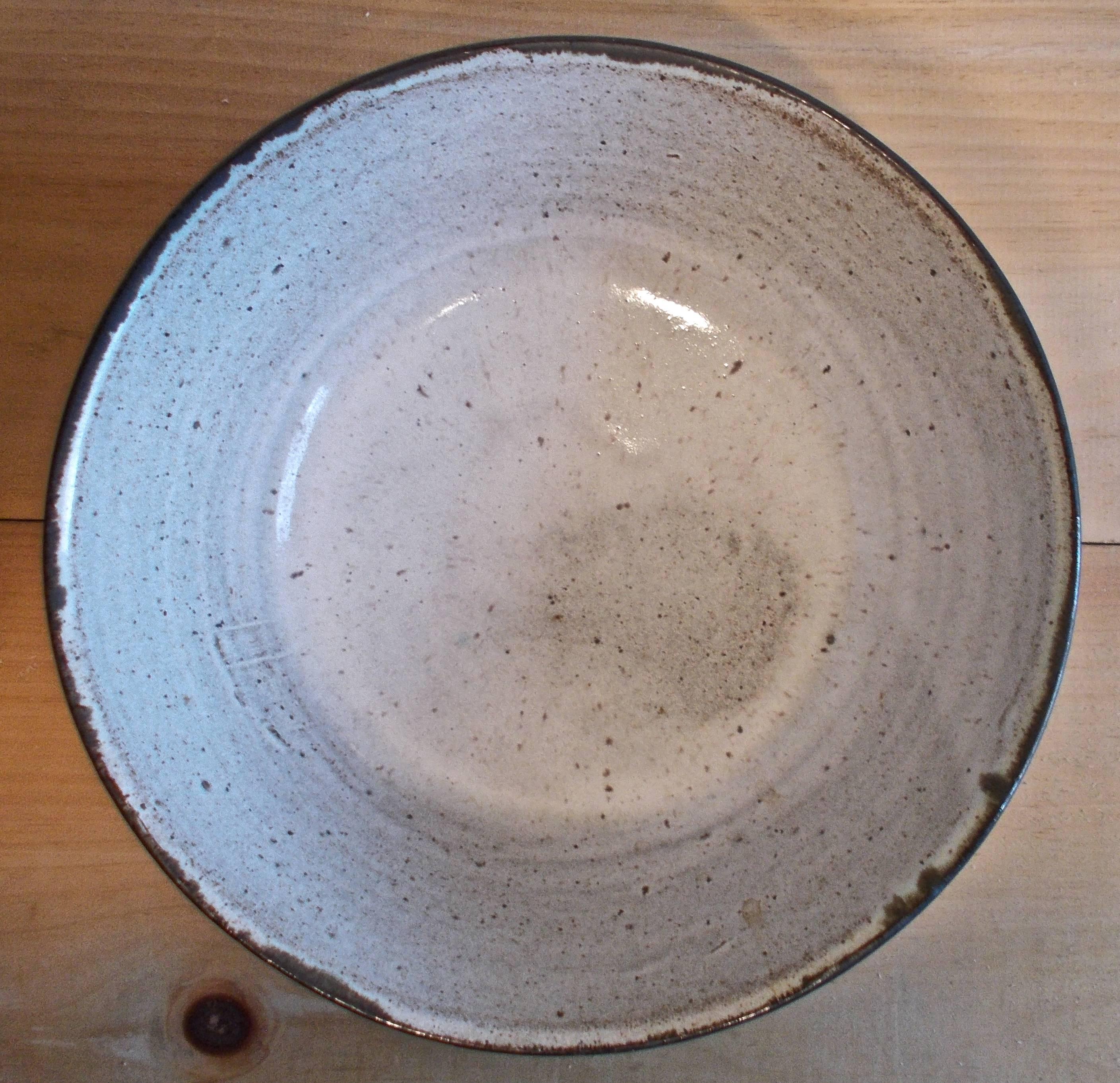 A beautiful bowl very much in Bauhaus aesthetic. Glazed white interior and exterior in 'gun metal'. Signed 'Wildenhain', could possibly mean Marguerite (Friedlander) as well.