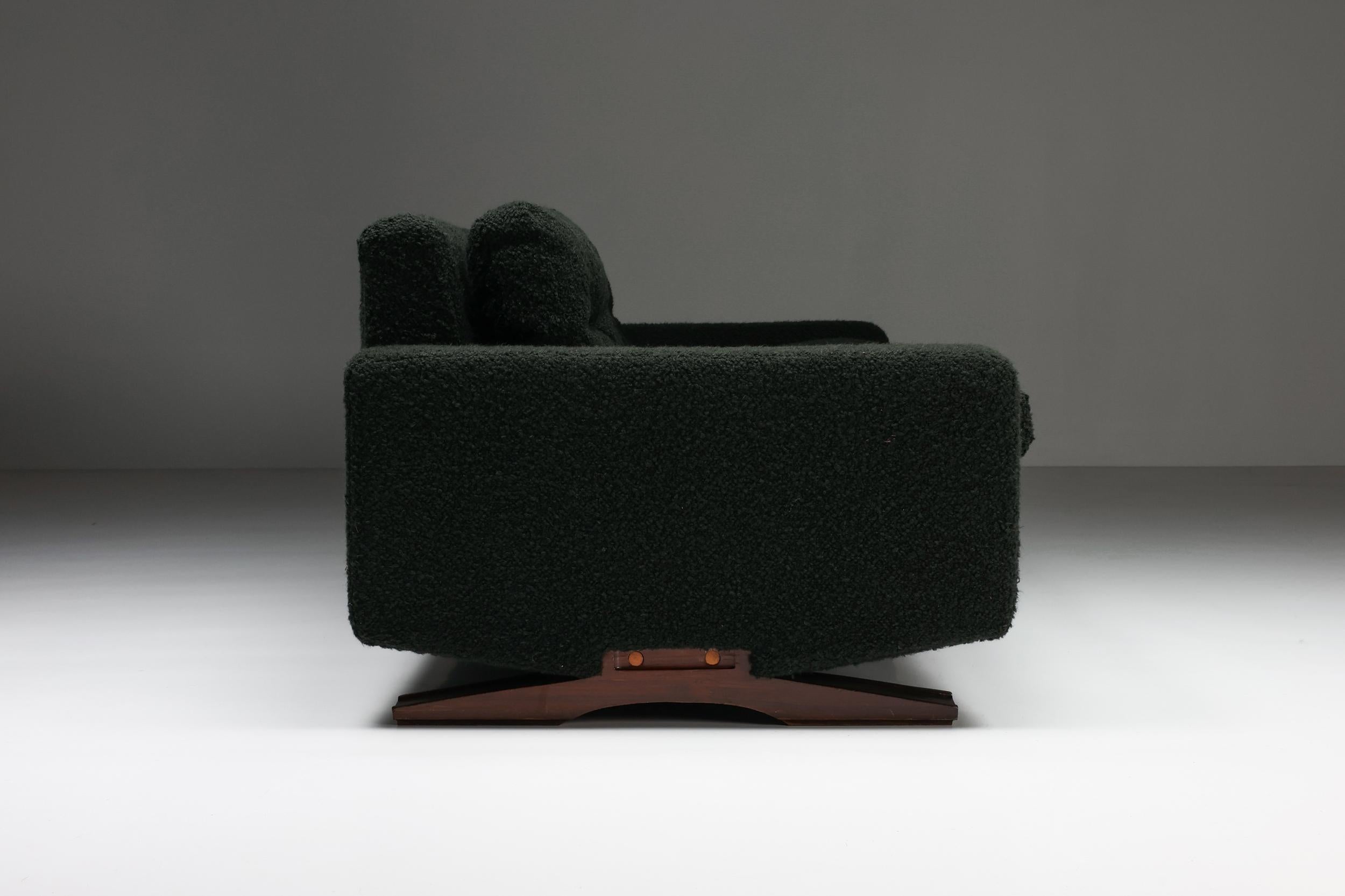 Italian design; Franz Sartori for Flexform, three-seater sofa, boucle, wood, Italy, the 1960s

Remarkable three-seater sofa in dark green boucle by the Italian sculptor Franz Sartori. This sofa features a modern design due to the straight lines.