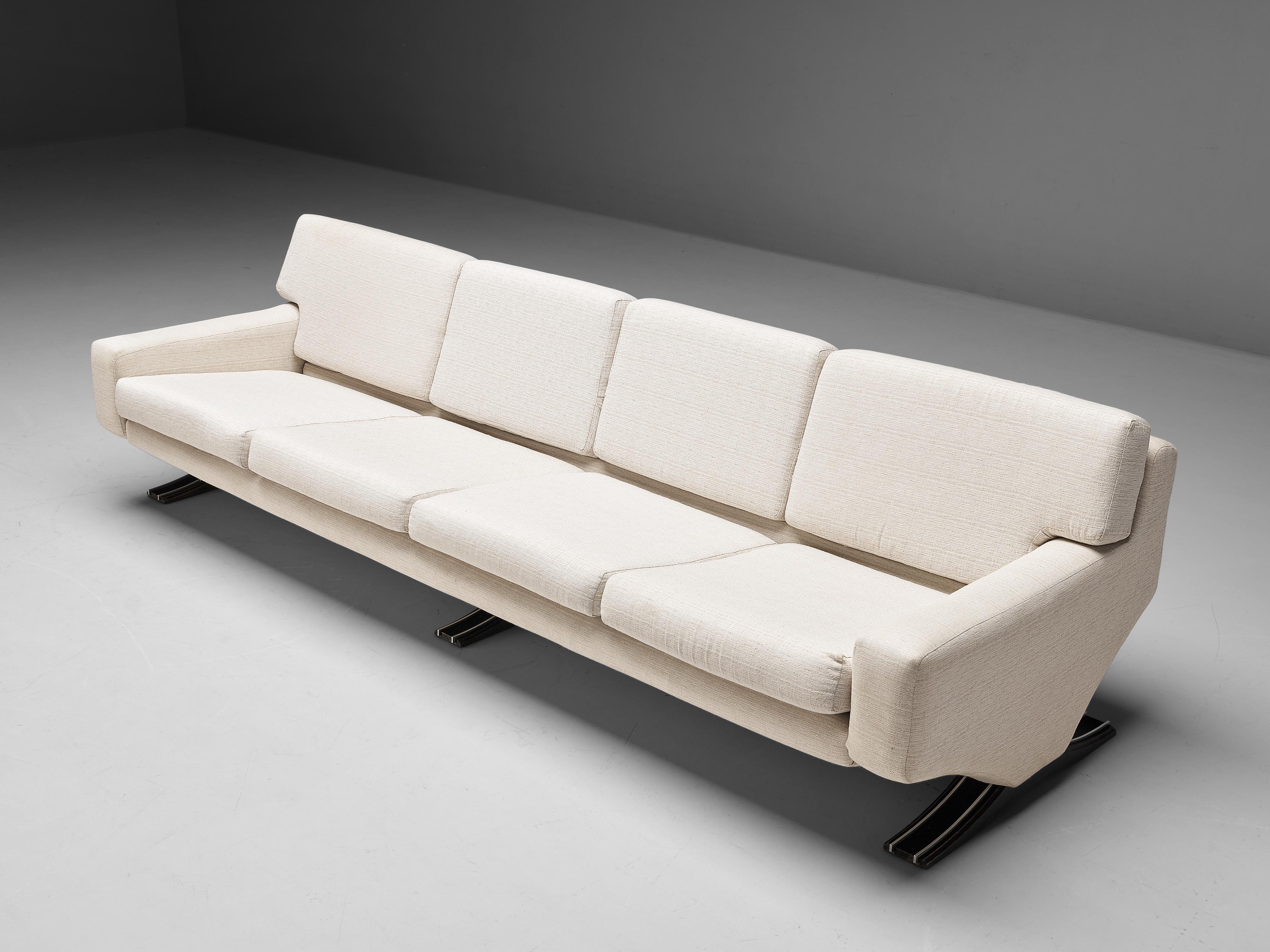 Franz T. Sartori, four seat sofa, fabric, wood, metal, Italy, 1970s

Bulky and grand sofa with sculptural feel. The large sofa has a strong appearance due to the straight lines in its design. The waved, sculptural legs lift the seat from the