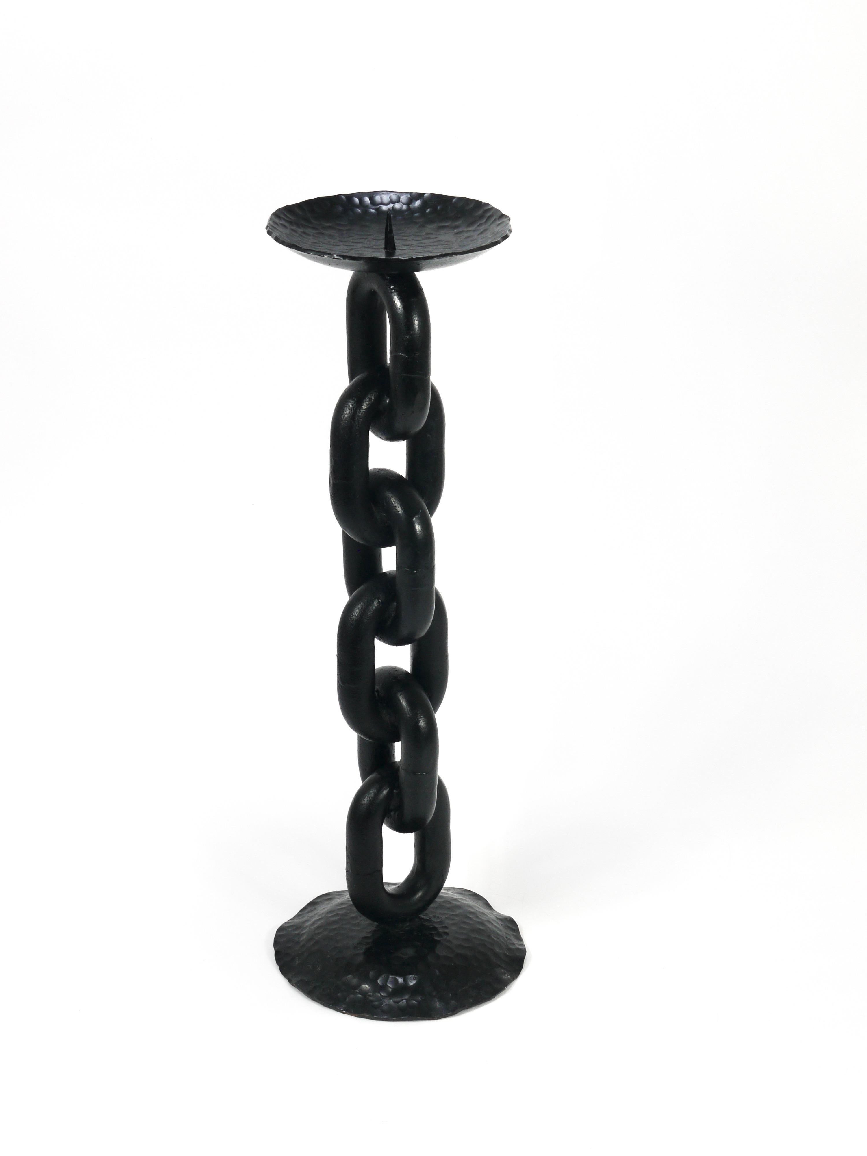 A decorative, large, and solid Brutalism candle holder / candlestick from the 1970s. Handmade in France from a heavy blackened nautical iron anchor chain with a hammer-blown top and base. In the manner of Franz West, it is made to hold large
