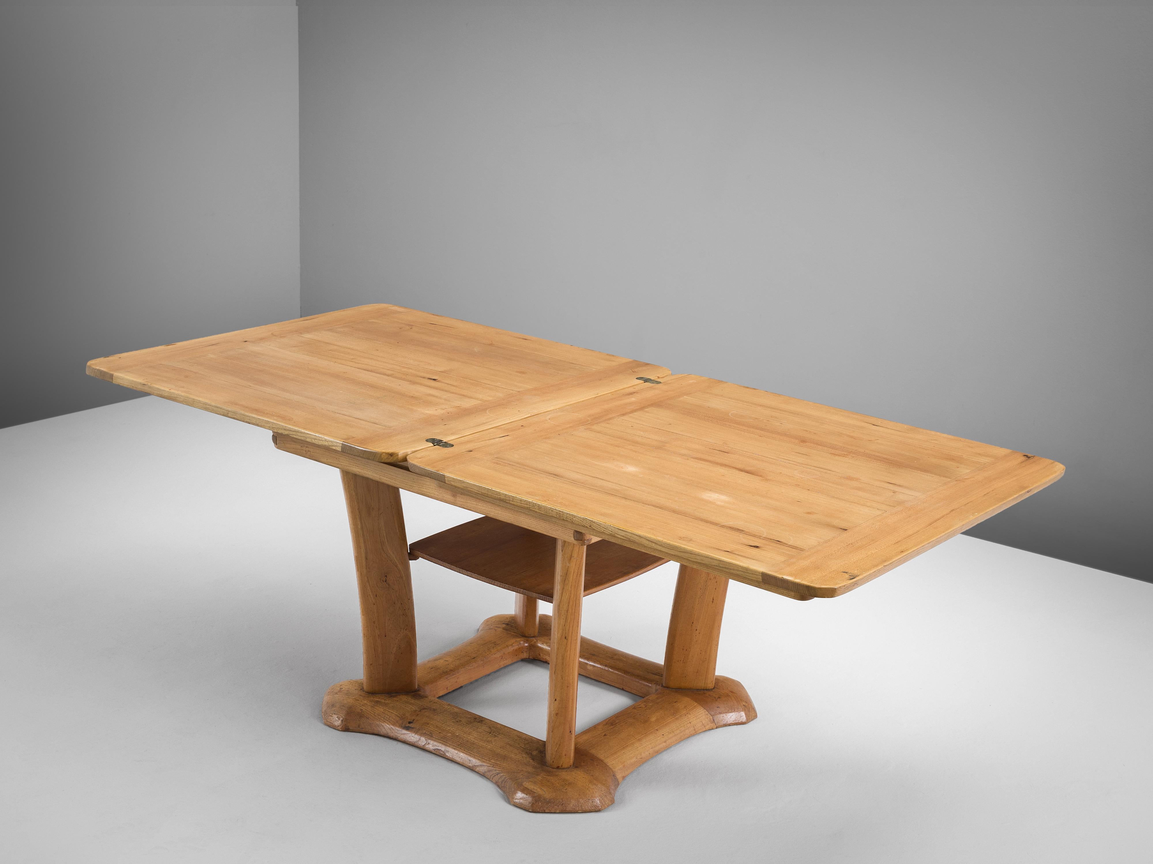 Franz Xaver Sproll, dining table, elm, brass, Switzerland, 1940s

This multifunctional dining table is a creation by Swiss designer Franz Xaver Sproll. In its most compact form design contains a square-shaped top. To expand its size, the top can be