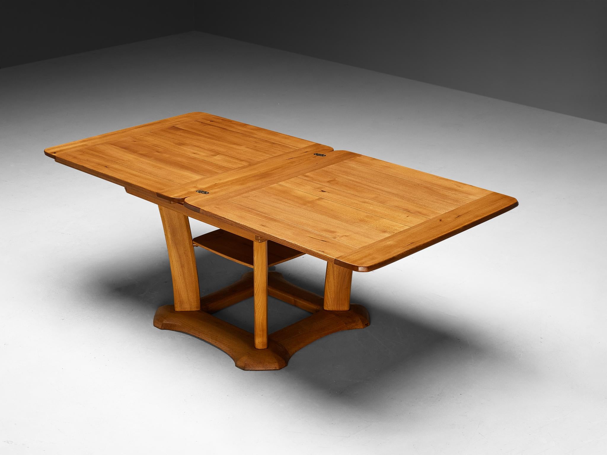 Franz Xaver Sproll, dining table, elm, brass, Switzerland, 1940s

This multifunctional dining table is a creation by Swiss designer Franz Xaver Sproll. In its most compact form design contains a square-shaped top. To expand its size, the top can be