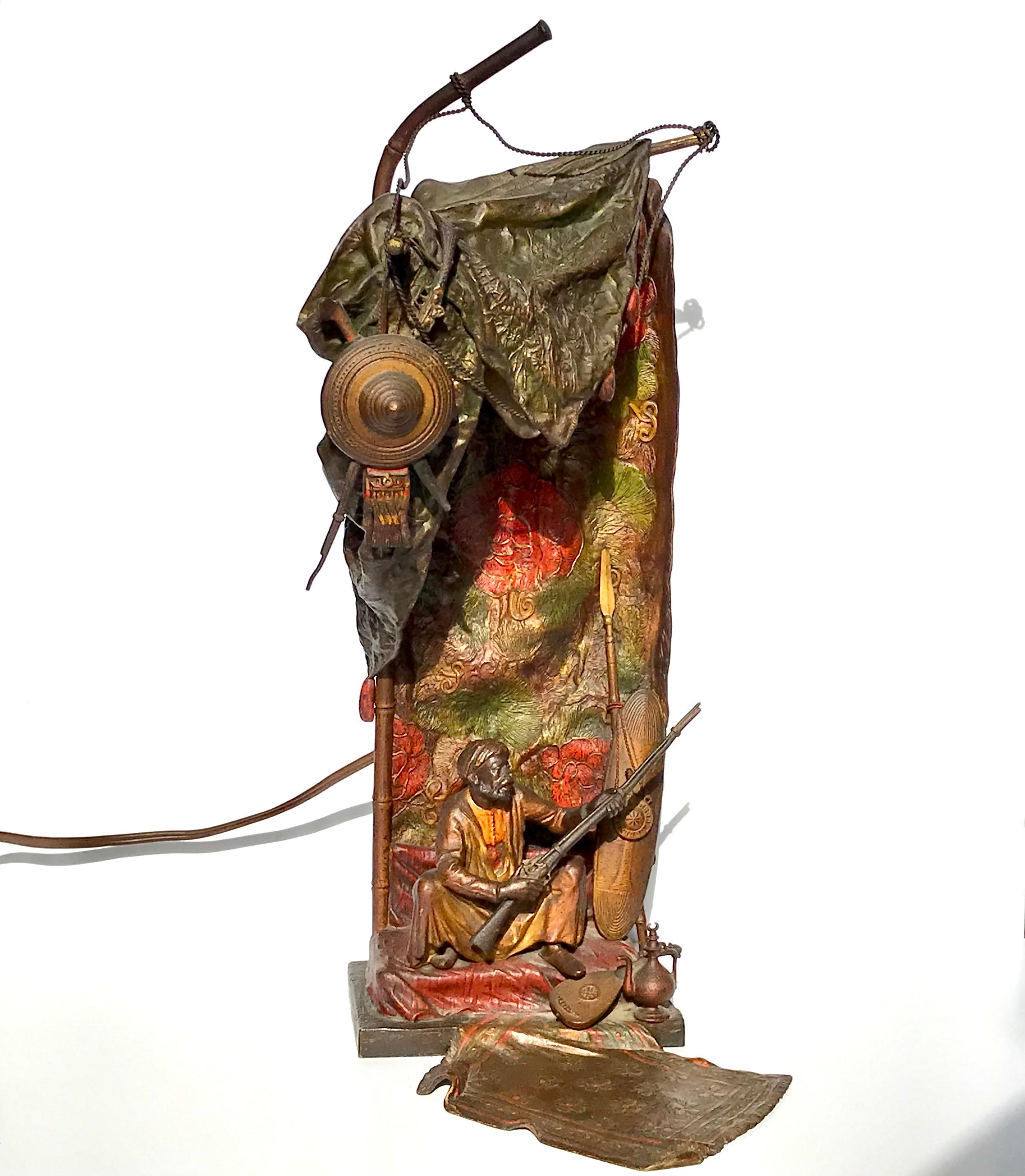 Franz Xavier Bergman (1861-1936) Namgreb Table lamp
Austrian cold painted bronze lamp of Bedouin guard sitting with his rifle in front of draped floral decorated tent, surrounded with a Persian rug, coffee pot, sitar, weapons, and shield.
Circa 1910